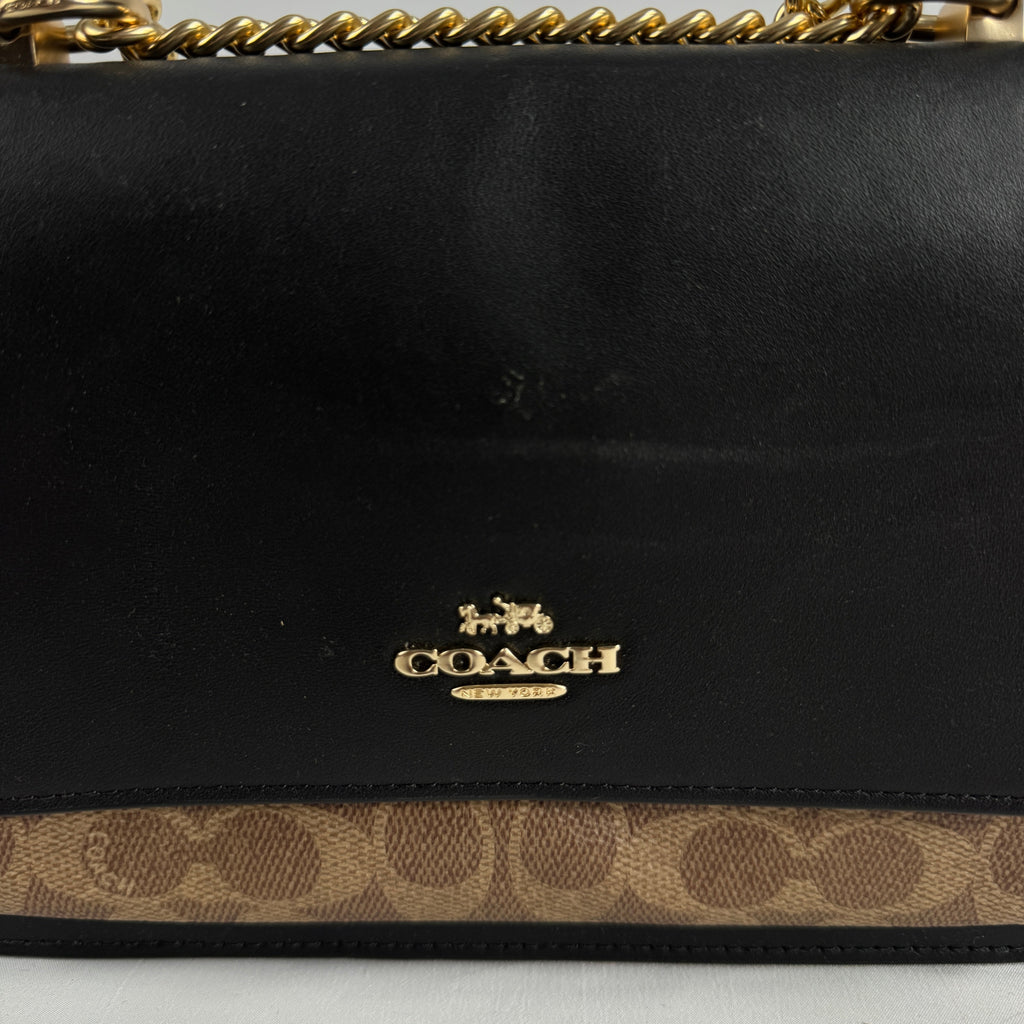 The Coach Klare Crossbody Bag is a structured leather bag with a flap closure, signature hardware, and an adjustable strap,