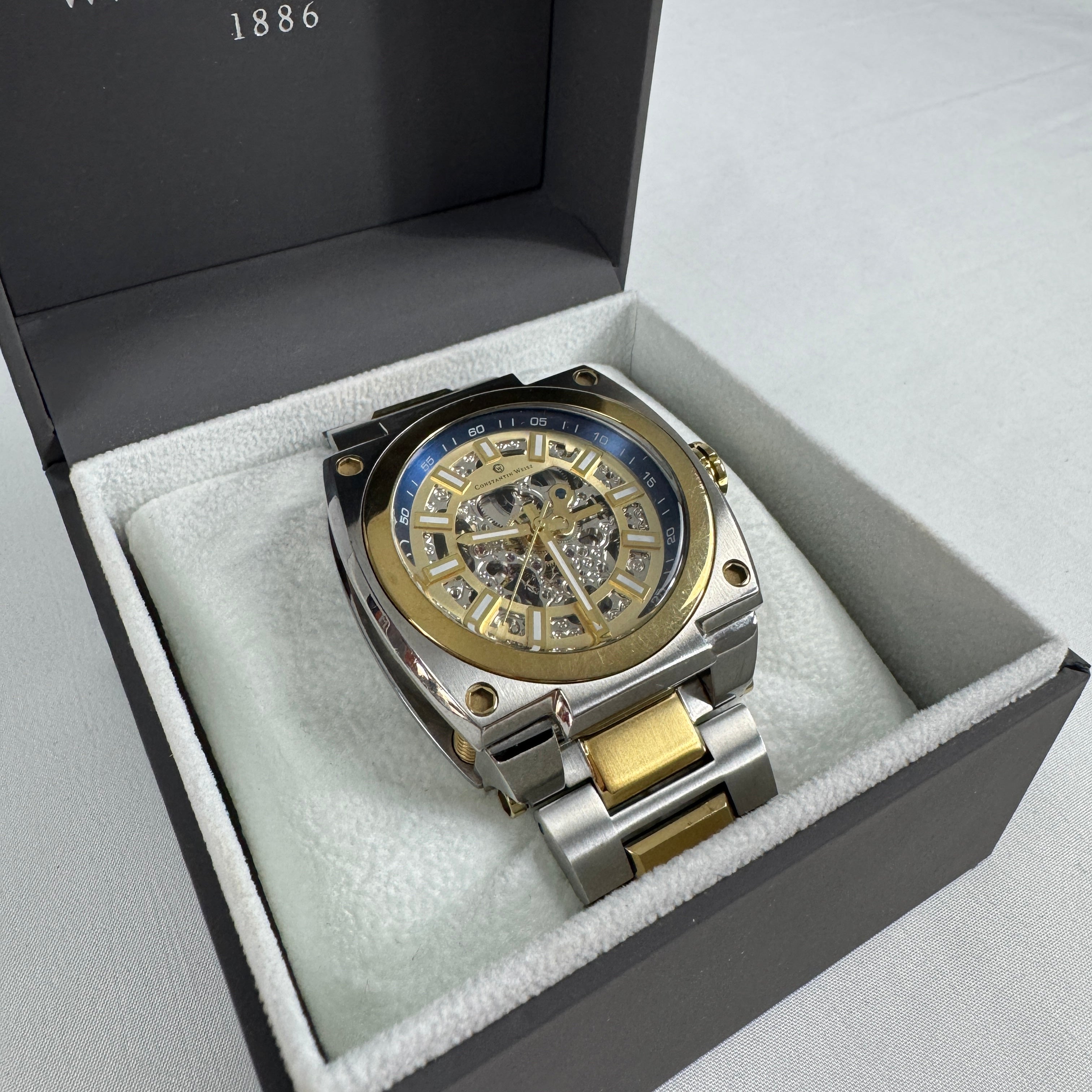 The Constantin Weisz Two Tone Skeleton Automatic is a mechanical watch featuring a visible skeleton dial, a stainless steel