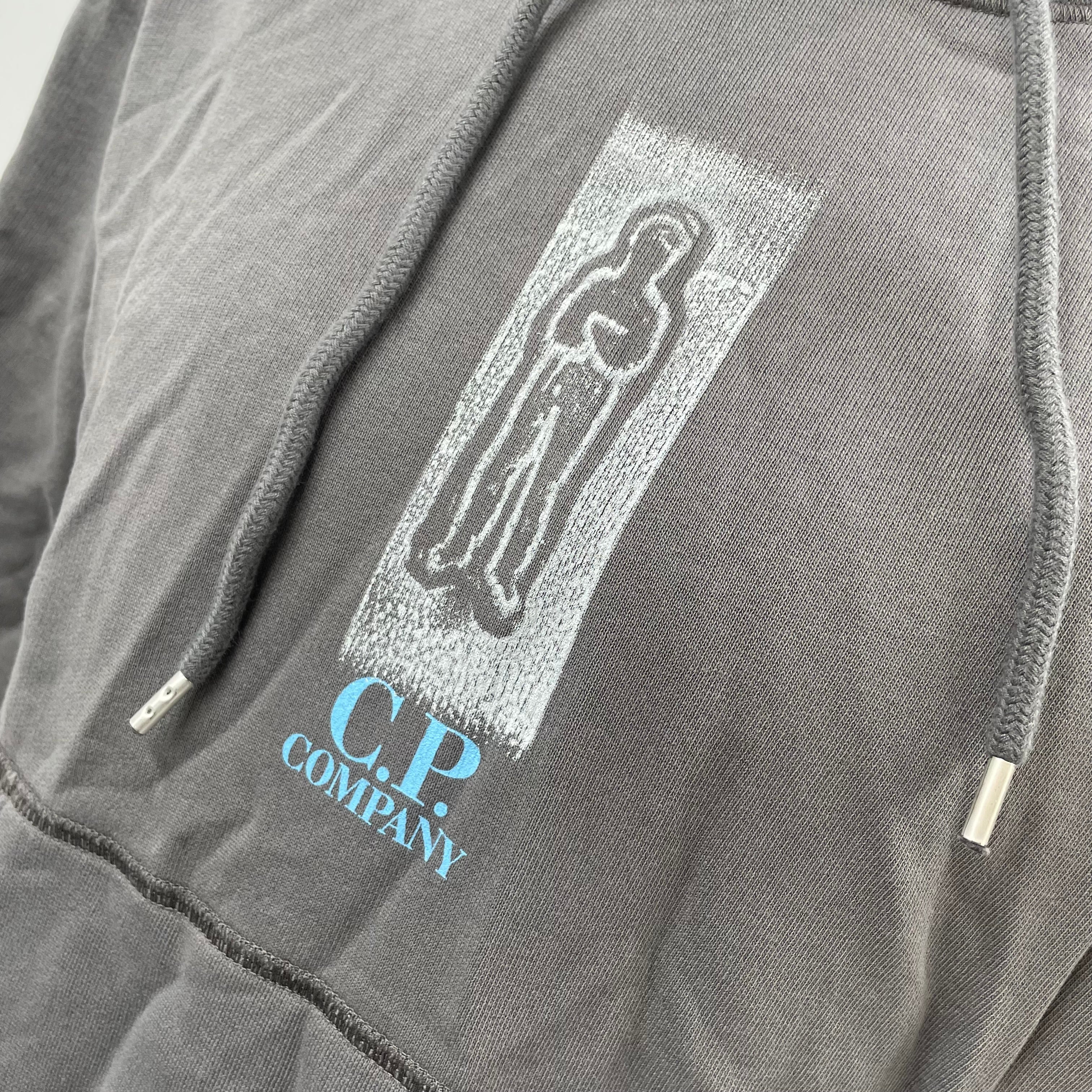 CP Company Graphic Hoodie crafted from premium cotton, featuring a bold graphic design, adjustable drawstring hood, ribbed