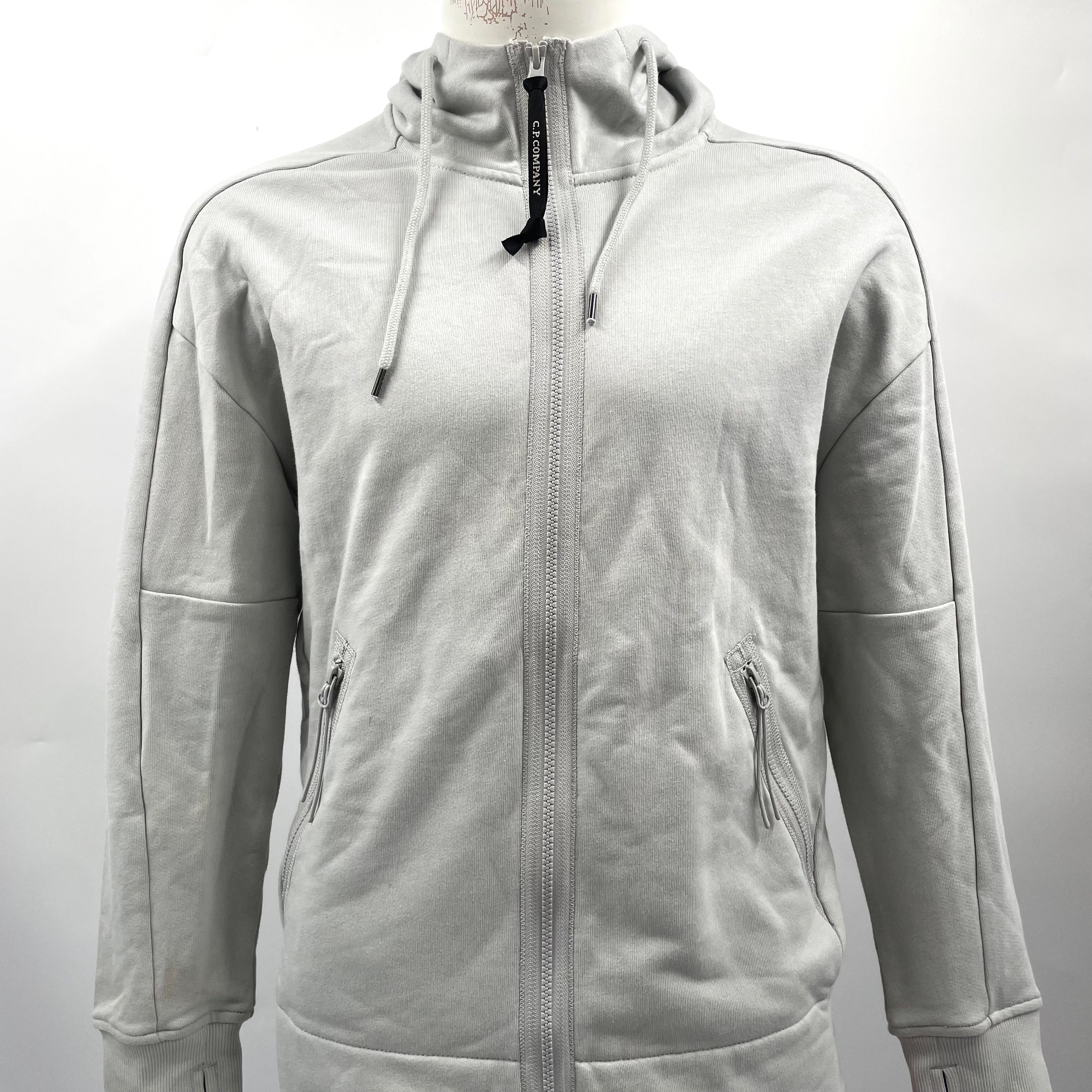 CP Company Hooded Zipup Grey crafted from premium fabric, featuring a full zip closure, adjustable hood, signature C.P.