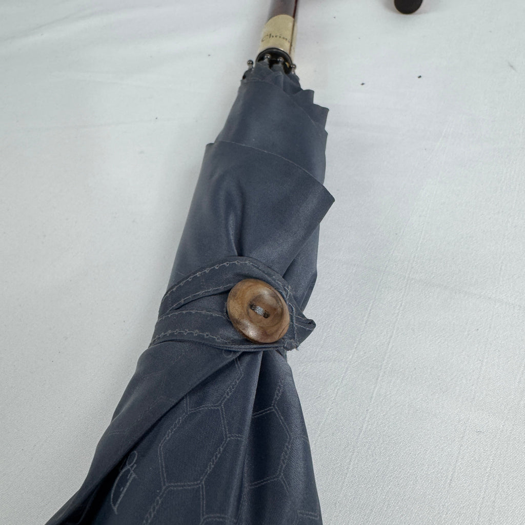 The Dior Walk’N’Dior Umbrella is a luxury rain accessory featuring signature Dior monogram detailing, a refined foldable