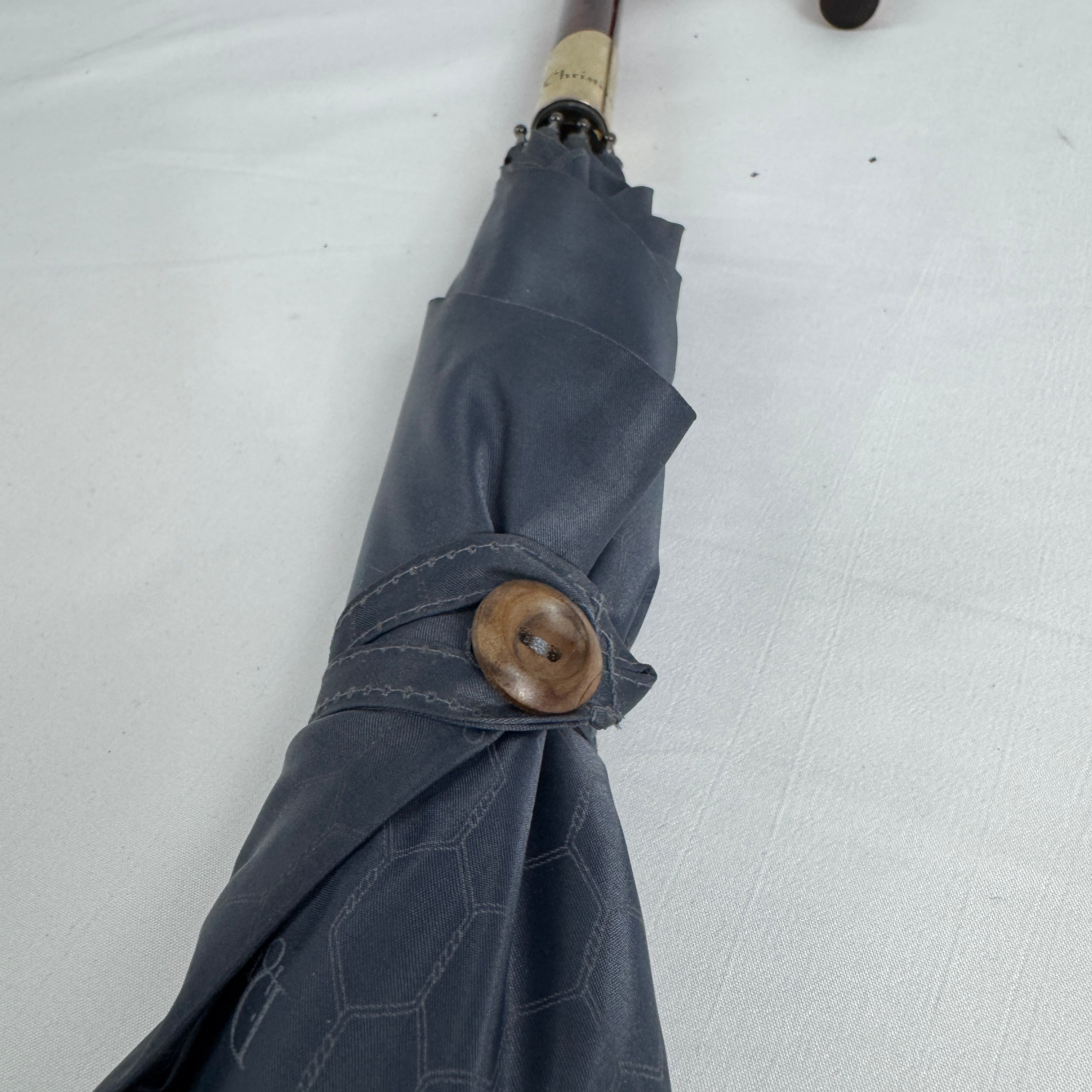 The Dior Walk’N’Dior Umbrella is a luxury rain accessory featuring signature Dior monogram detailing, a refined foldable