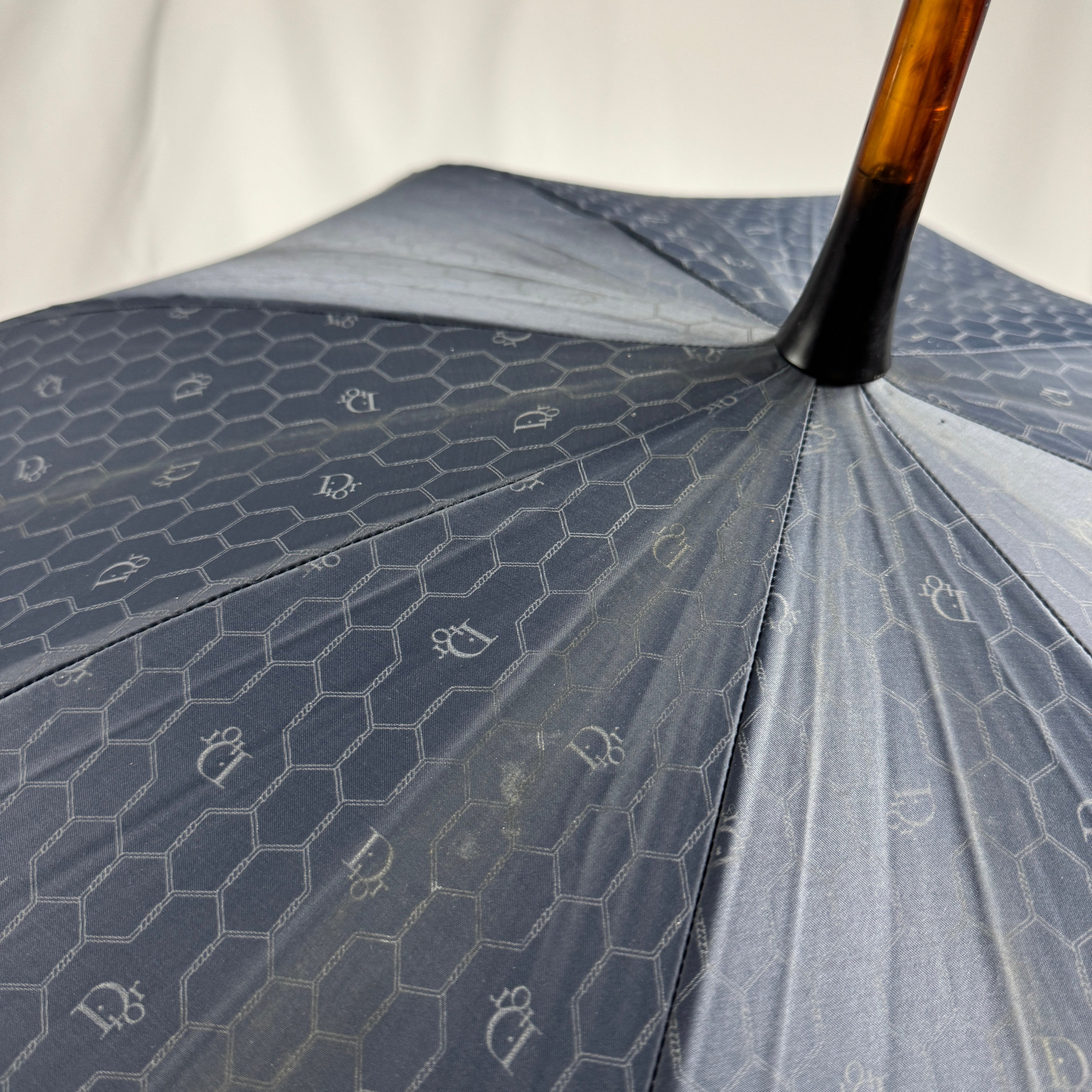 The Dior Walk’N’Dior Umbrella is a luxury rain accessory featuring signature Dior monogram detailing, a refined foldable