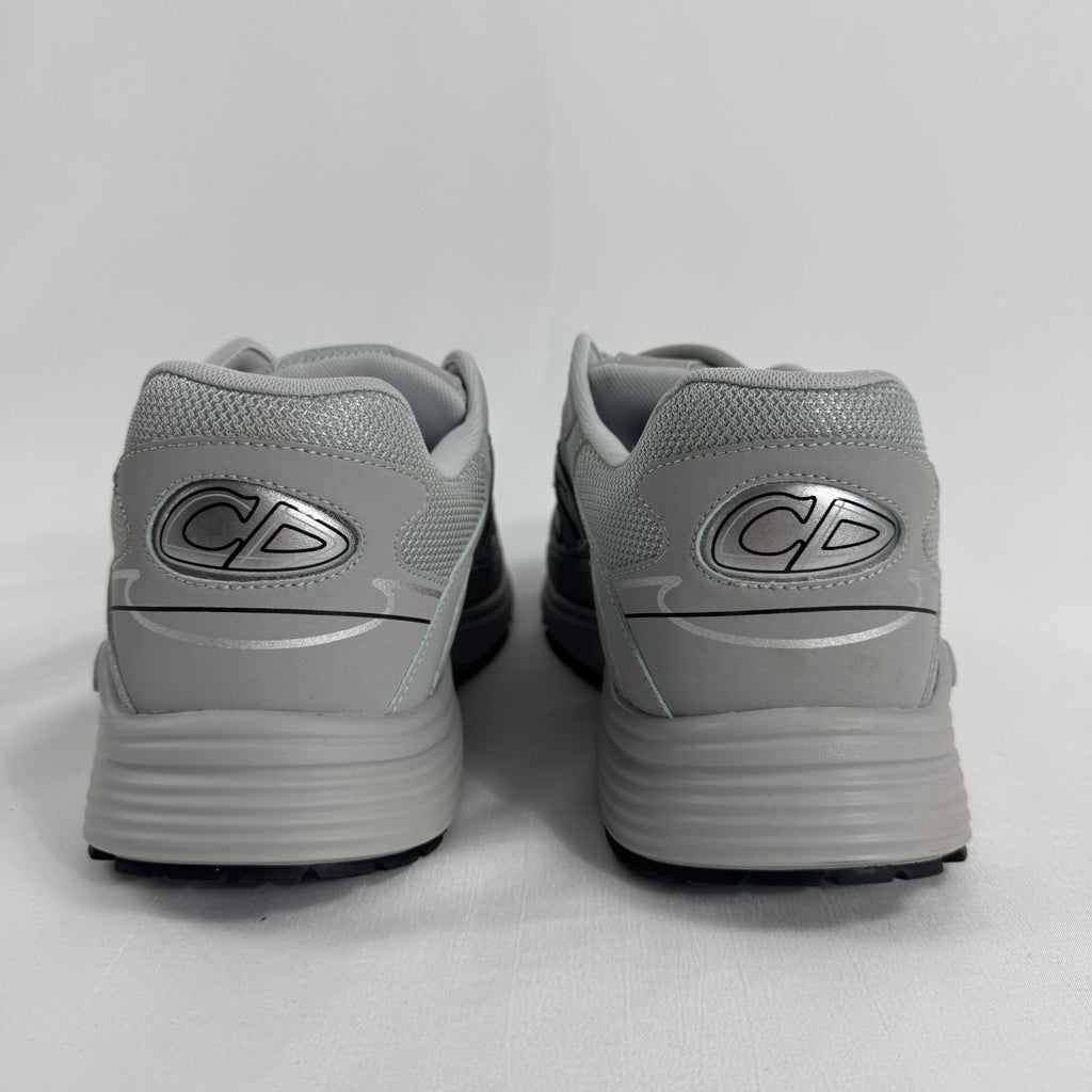The Dior B30 Grey is a luxury sneaker featuring a technical mesh and microfiber upper in grey tones, with reflective