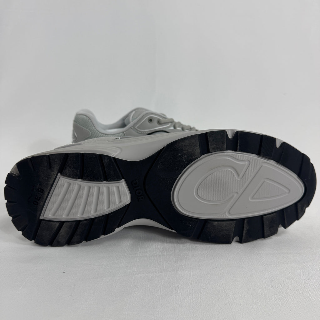 The Dior B30 Grey is a luxury sneaker featuring a technical mesh and microfiber upper in grey tones, with reflective