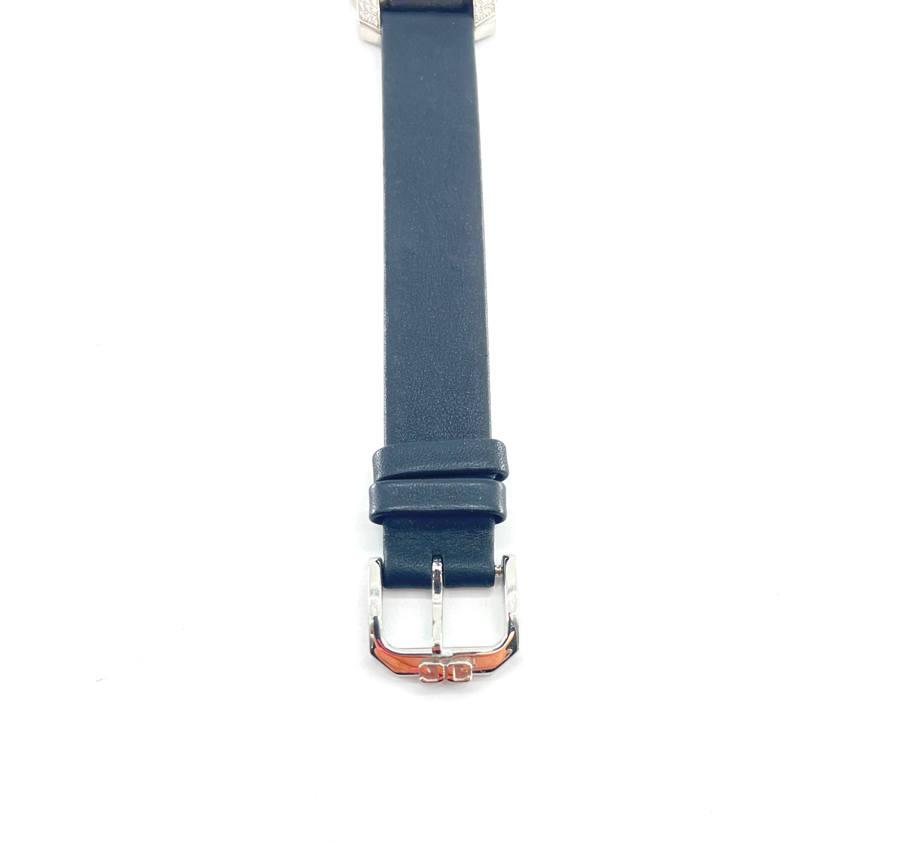 Close-up of a Glashutte watch with a dark blue strap and silver buckle, displayed vertically on a white background.