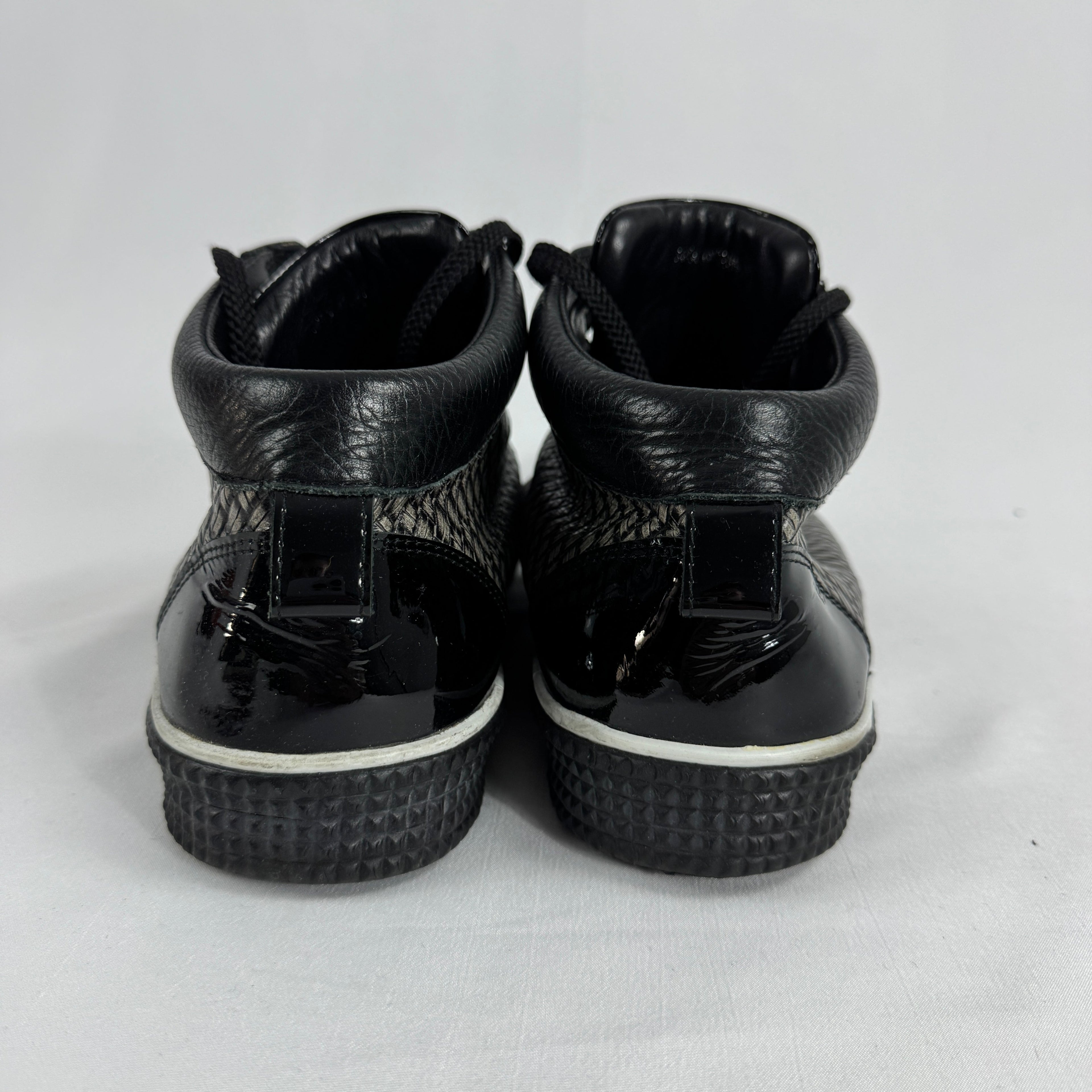 The Jimmy Choo Belgravia High-Top is a luxury sneaker that combines contemporary streetwear style with premium