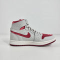 Jordan 1 Mid Zoom Grey/Red is a stylish mid-top sneaker featuring a grey upper with bold red accents for a striking look. It
