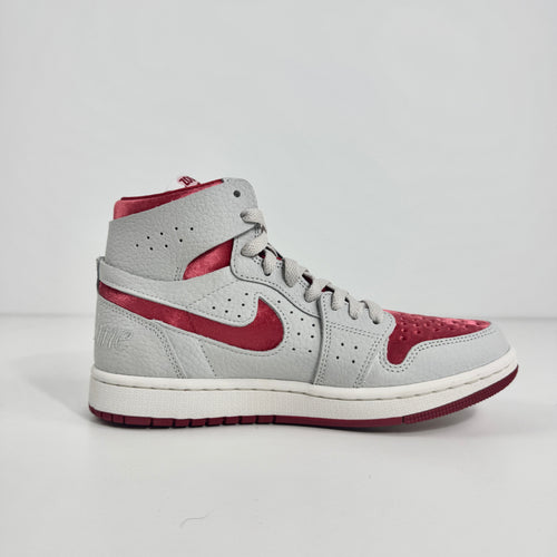 Jordan 1 Mid Zoom Grey/Red is a stylish mid-top sneaker featuring a grey upper with bold red accents for a striking look. It