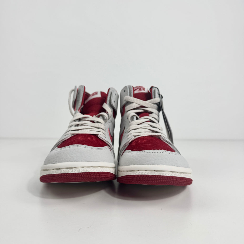Jordan 1 Mid Zoom Grey/Red is a stylish mid-top sneaker featuring a grey upper with bold red accents for a striking look. It