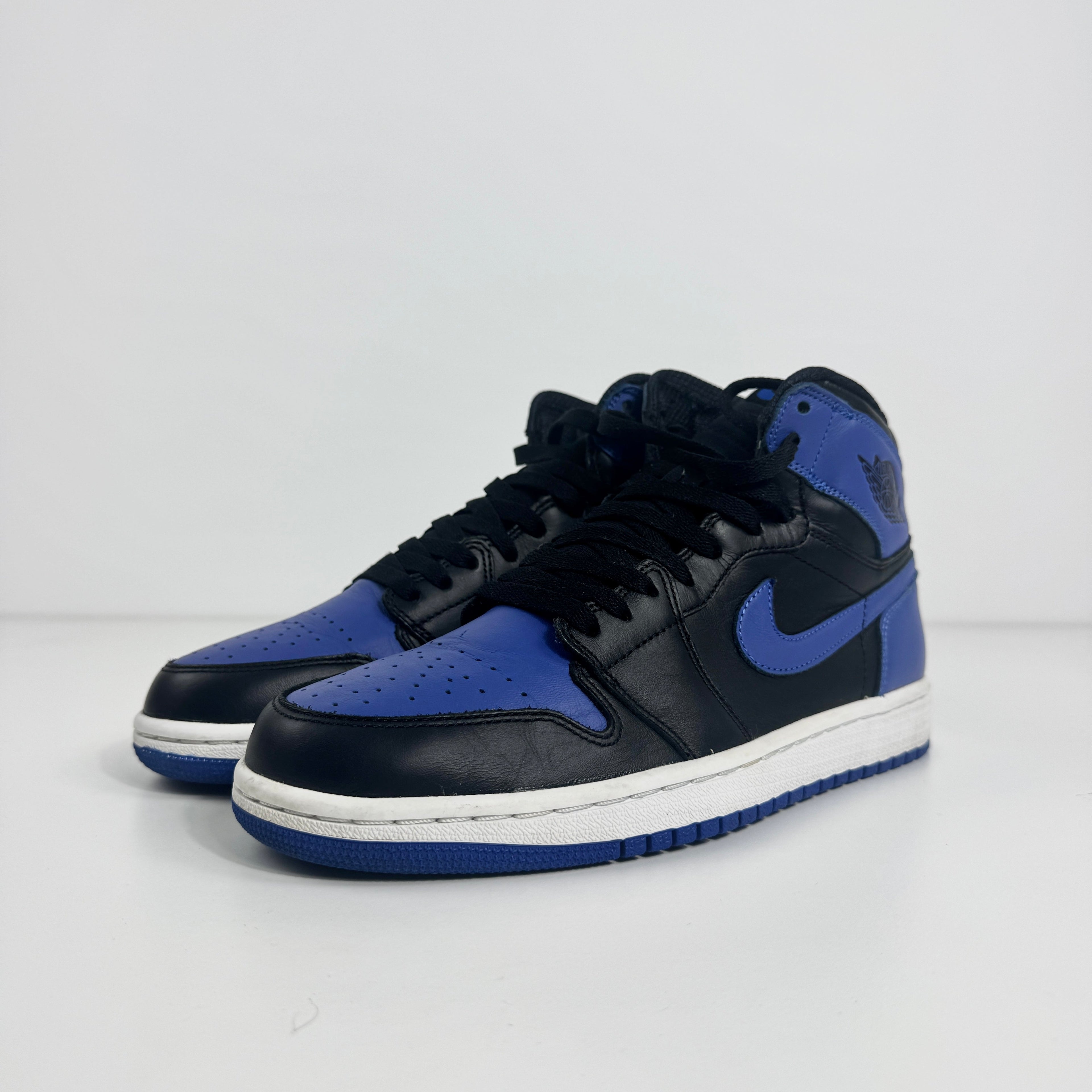 Black and royal blue Nike high-top trainers with white midsoles and blue outsoles, displayed on a plain white background.
