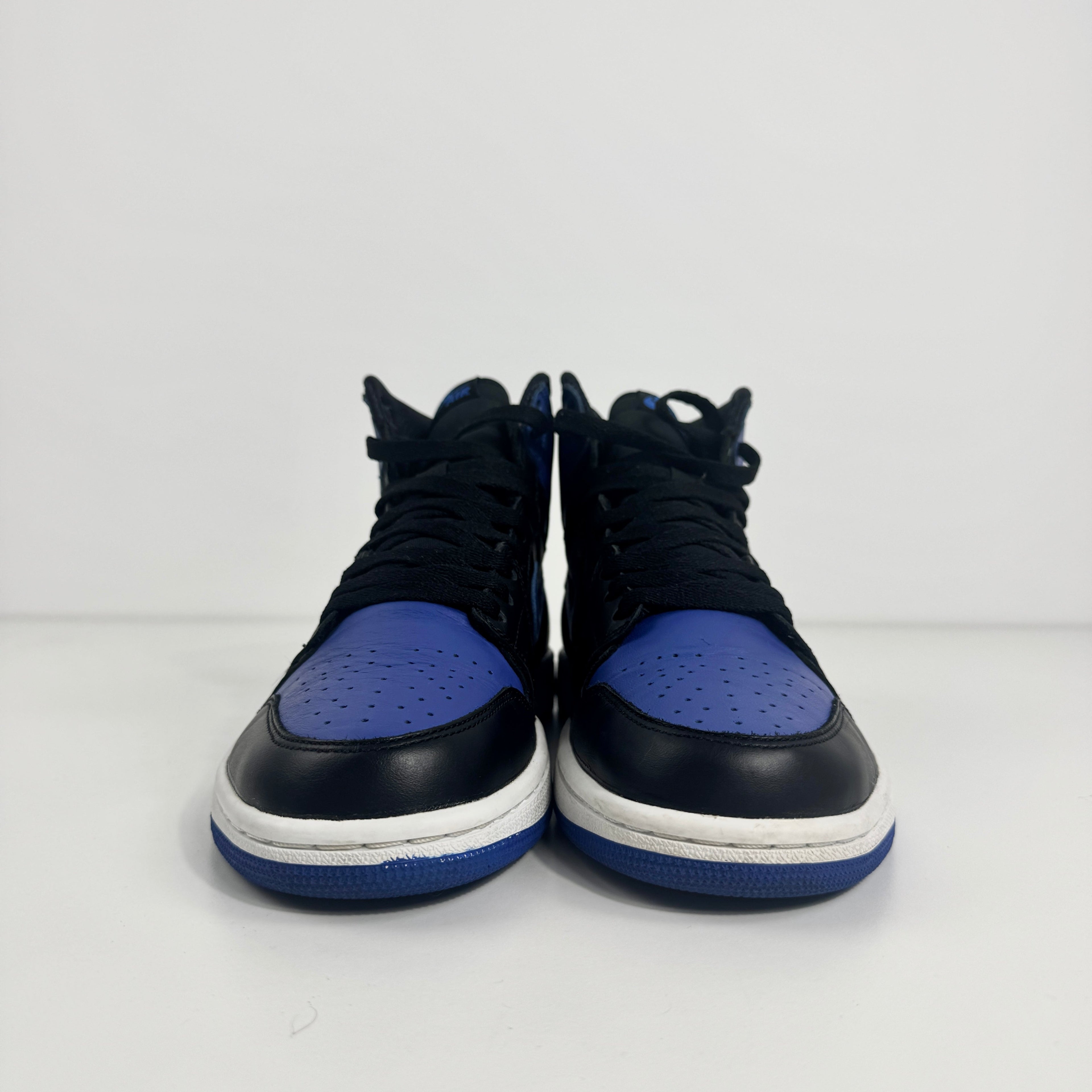 Two black and royal blue Nike high-top trainers are positioned side by side on a plain white background, shown from the front.