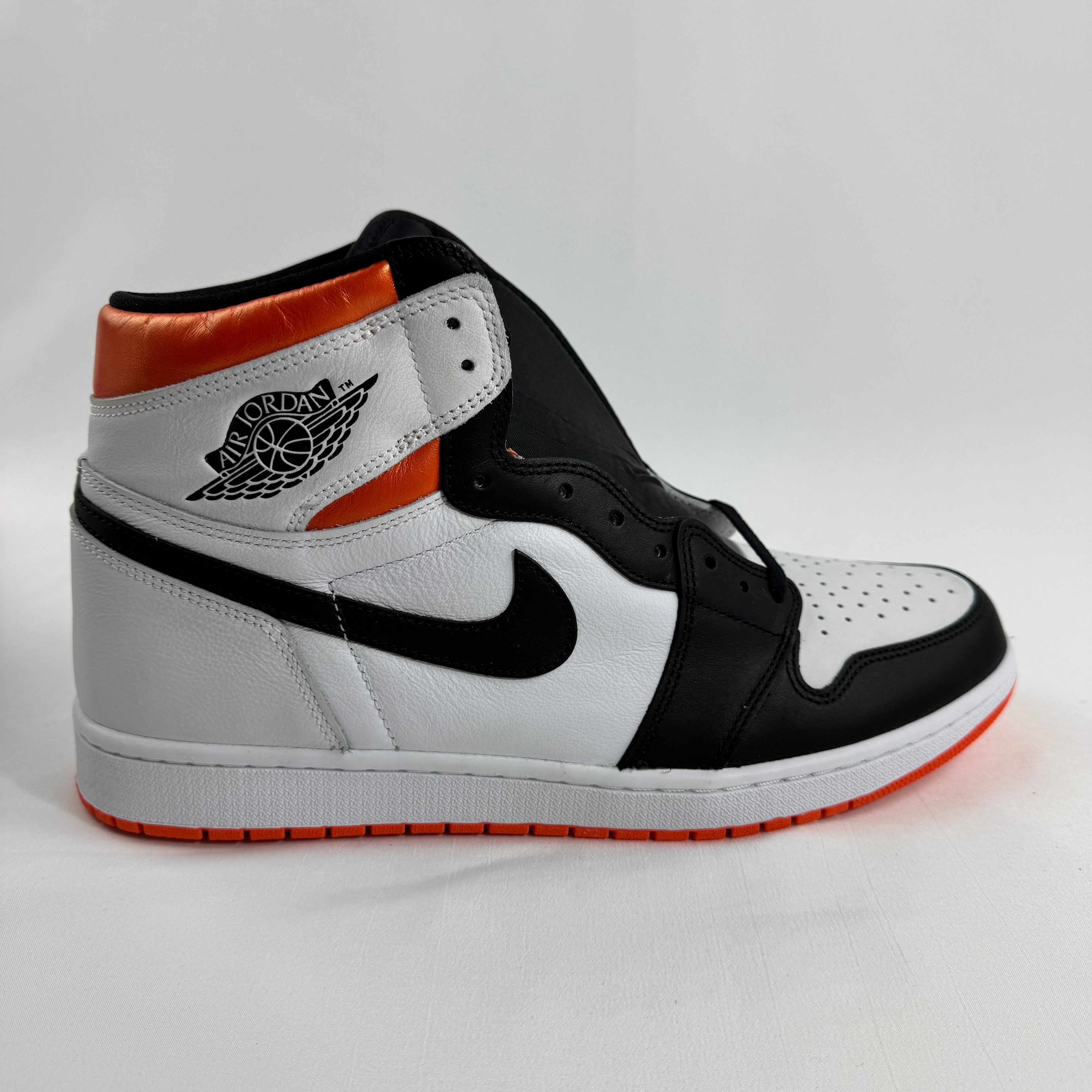 is a bold take on the iconic Air Jordan 1 silhouette, featuring a clean white and black base accented by vibrant Electro