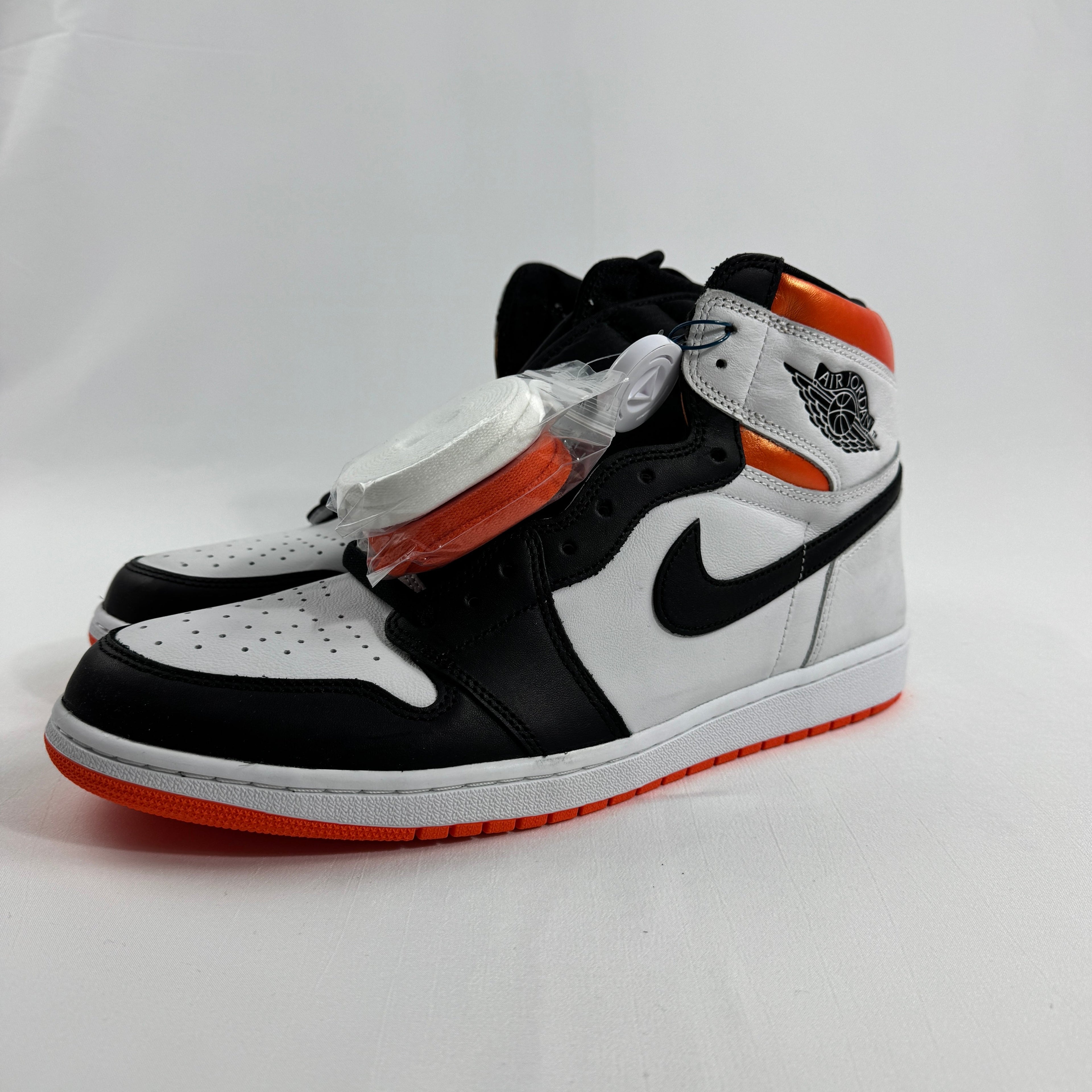 is a bold take on the iconic Air Jordan 1 silhouette, featuring a clean white and black base accented by vibrant Electro
