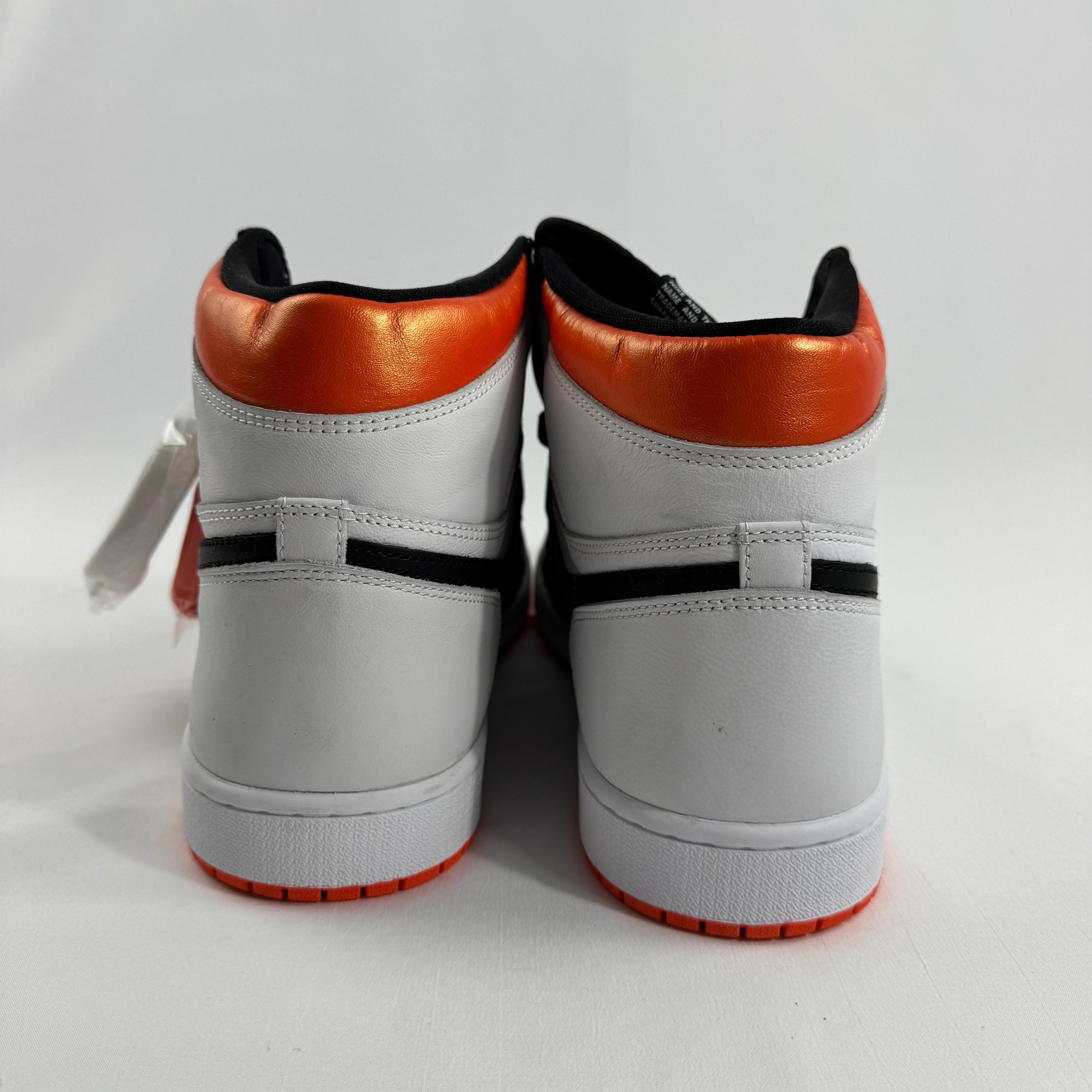 is a bold take on the iconic Air Jordan 1 silhouette, featuring a clean white and black base accented by vibrant Electro