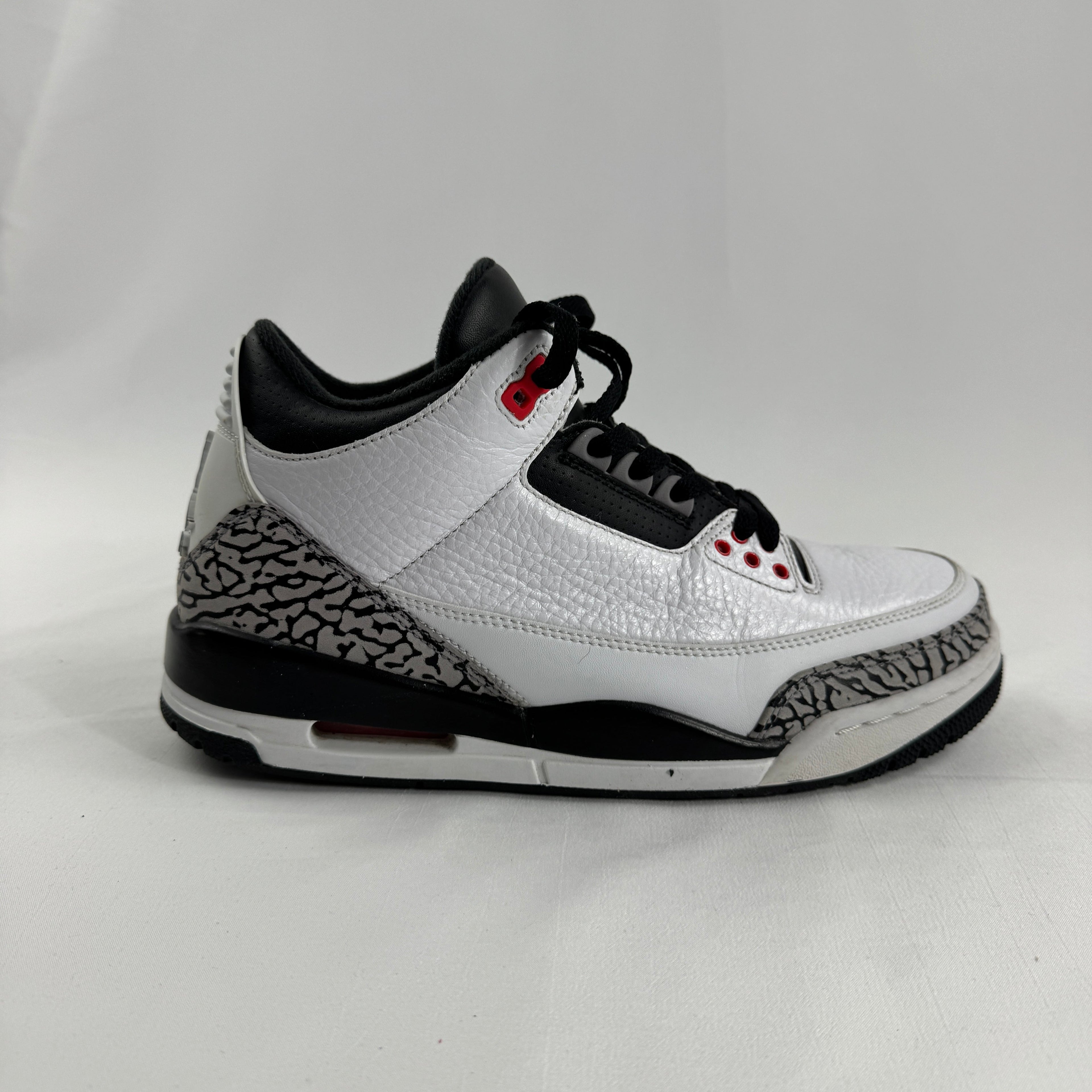 The Air Jordan 3 Retro “Pure Money/Infrared” is a mostly white leather Jordan 3 with silver accents and subtle infrared red