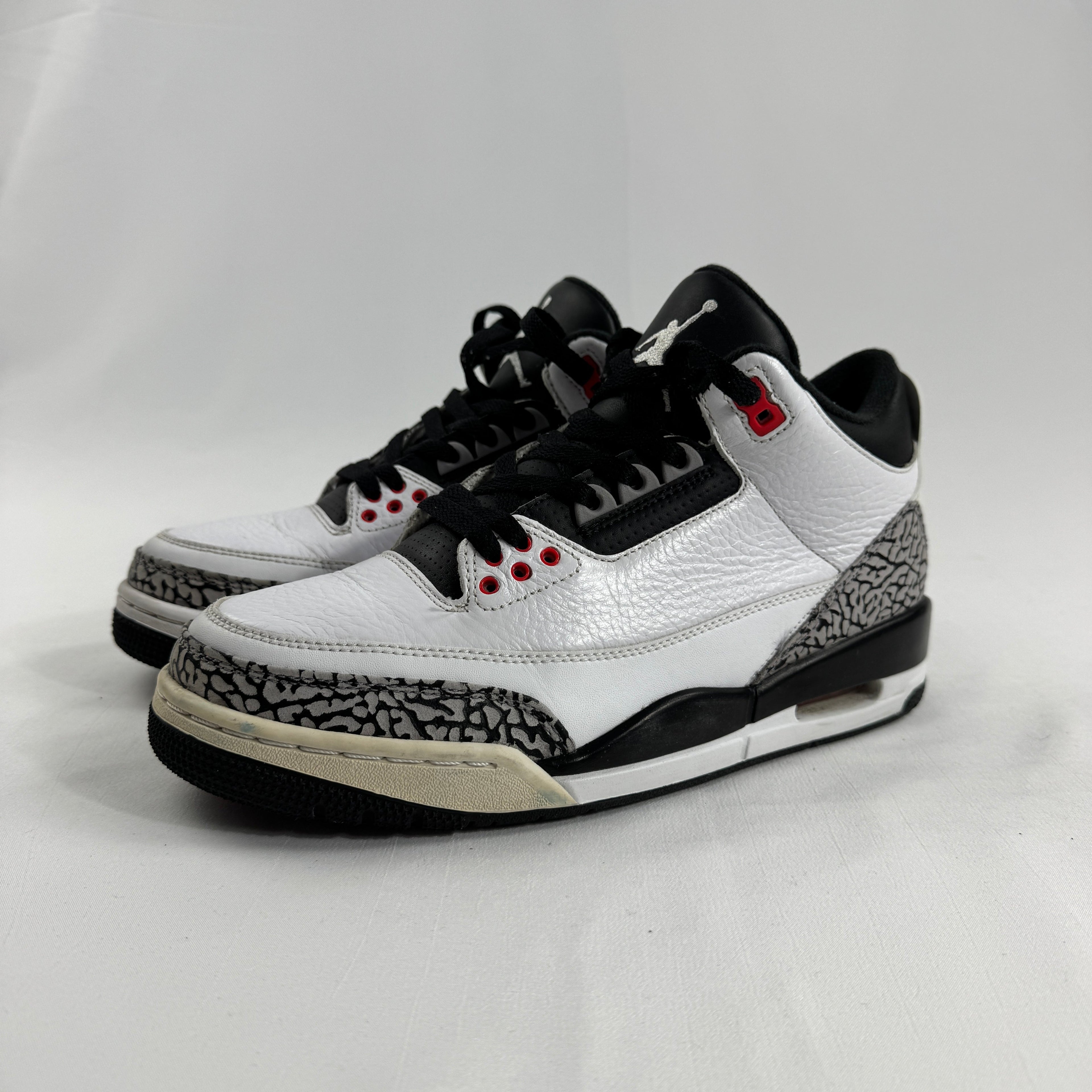 The Air Jordan 3 Retro “Pure Money/Infrared” is a mostly white leather Jordan 3 with silver accents and subtle infrared red