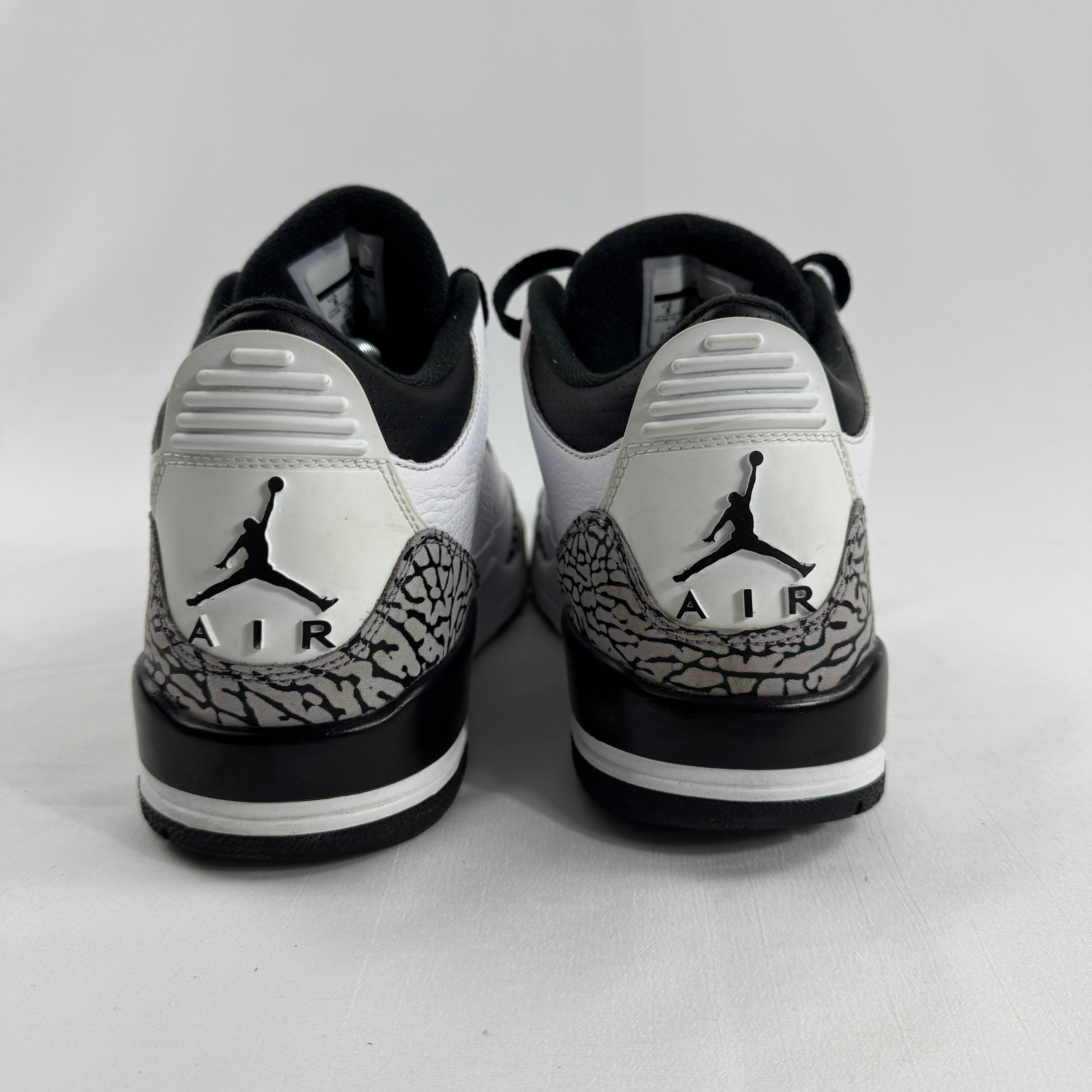 The Air Jordan 3 Retro “Pure Money/Infrared” is a mostly white leather Jordan 3 with silver accents and subtle infrared red