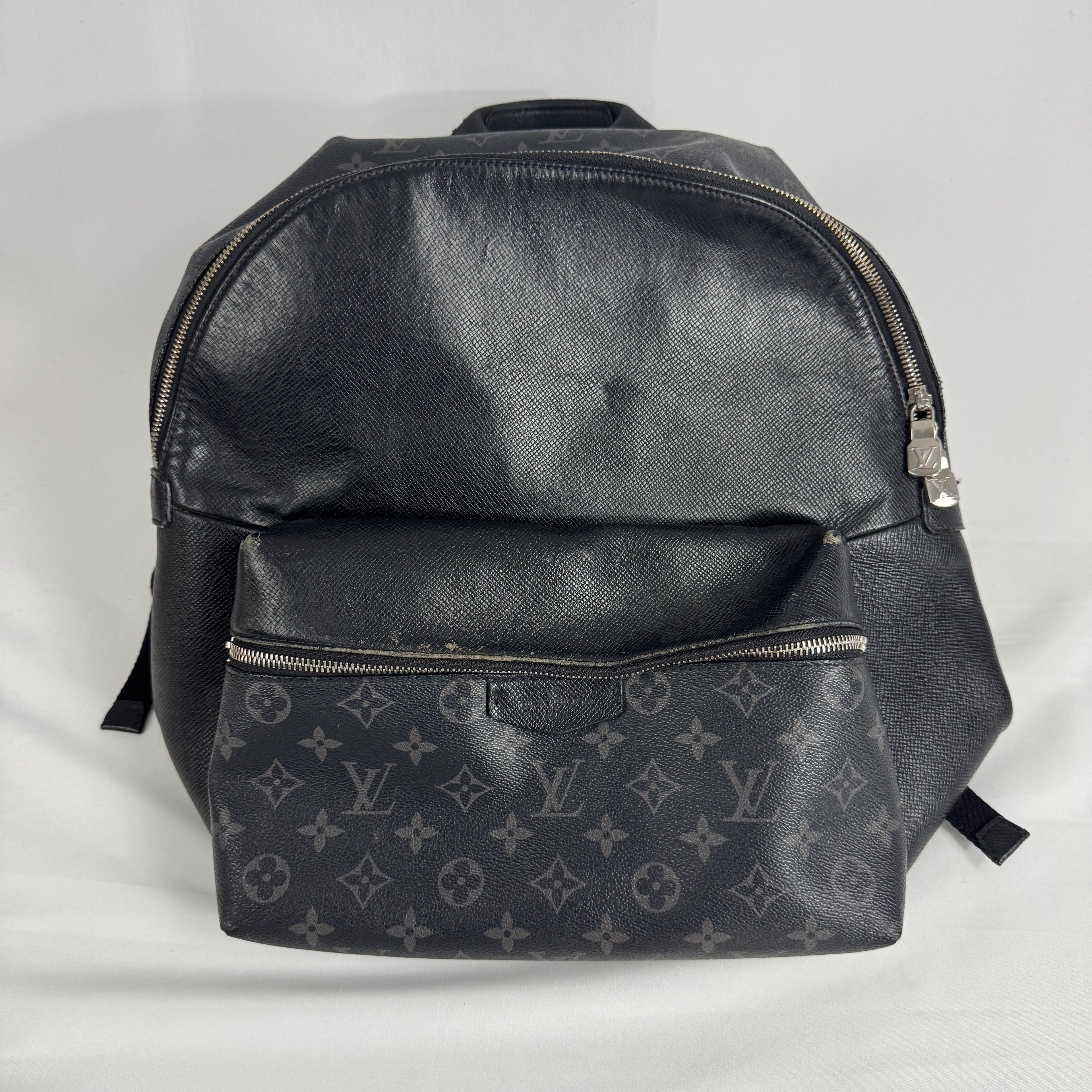 The Louis Vuitton Taigarama Discovery Backpack is a sleek, lightweight backpack made from durable Taiga leather and coated