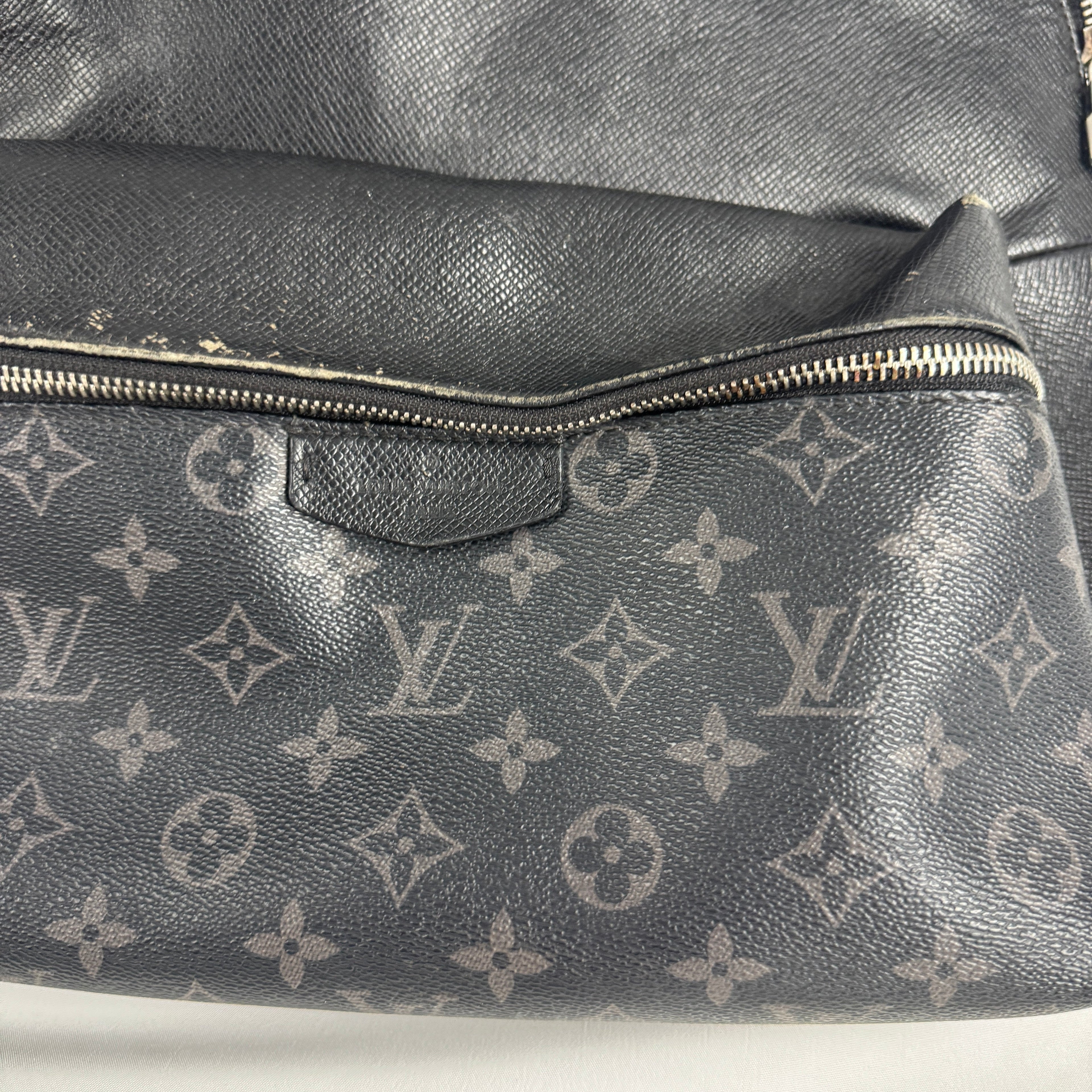 The Louis Vuitton Taigarama Discovery Backpack is a sleek, lightweight backpack made from durable Taiga leather and coated