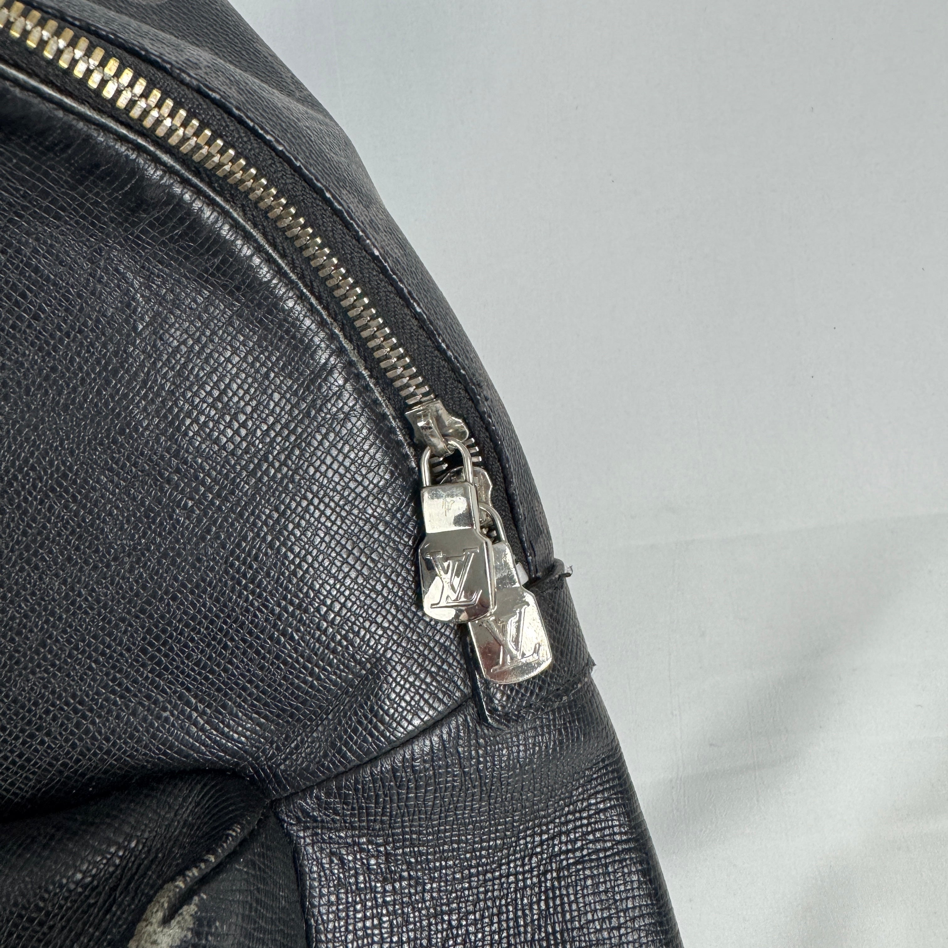 The Louis Vuitton Taigarama Discovery Backpack is a sleek, lightweight backpack made from durable Taiga leather and coated