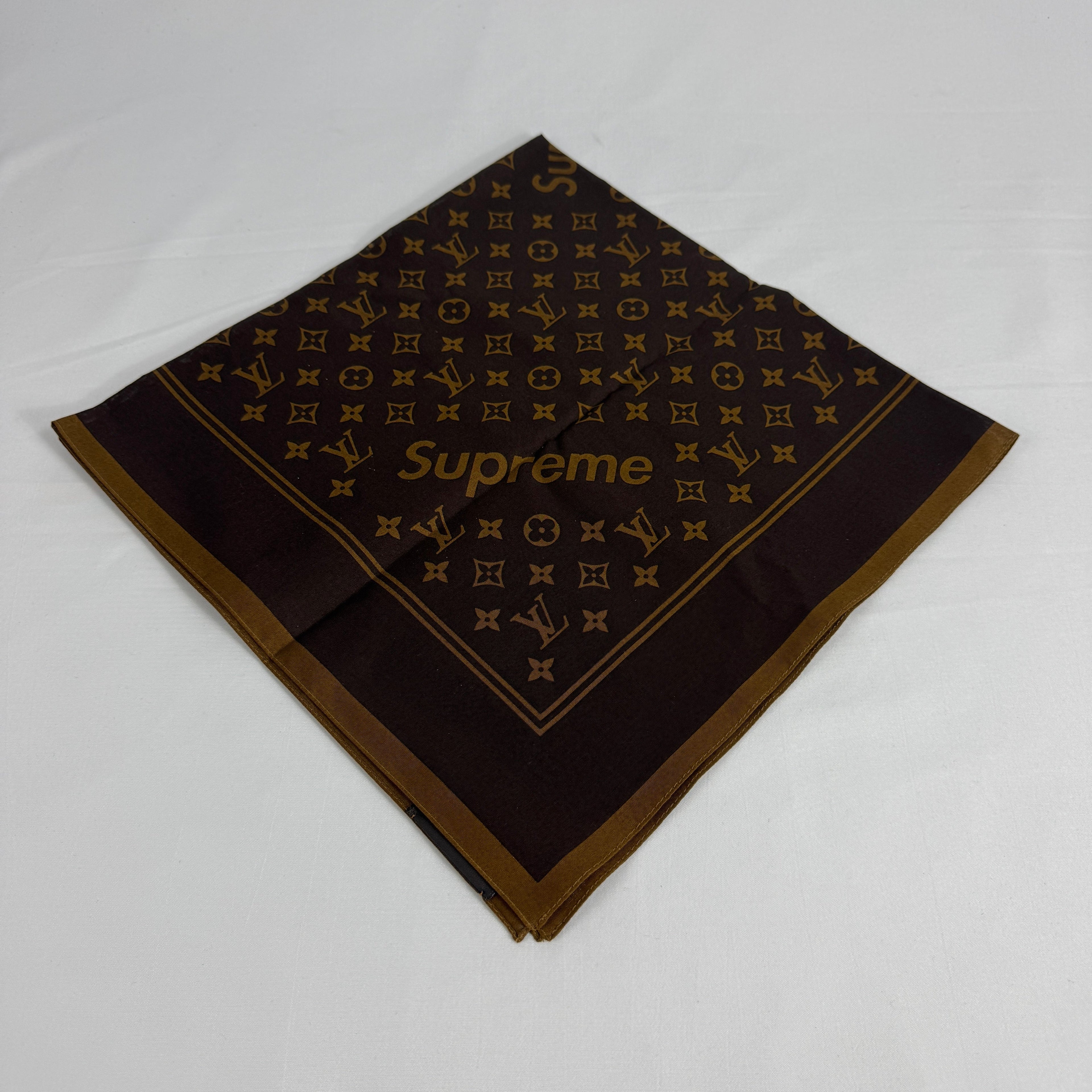 The Louis Vuitton x Supreme headscarf is a rare collaboration accessory featuring luxury silk construction with bold