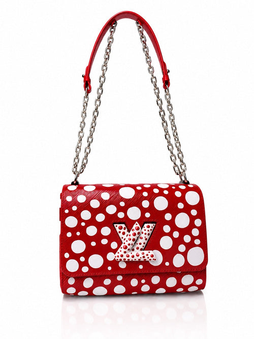 Red Louis Vuitton handbag with white polka dots, silver chain strap and LV logo on the front flap, against a plain white background.