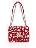Red Louis Vuitton handbag with white polka dots, silver chain strap and LV logo on the front flap, against a plain white background.