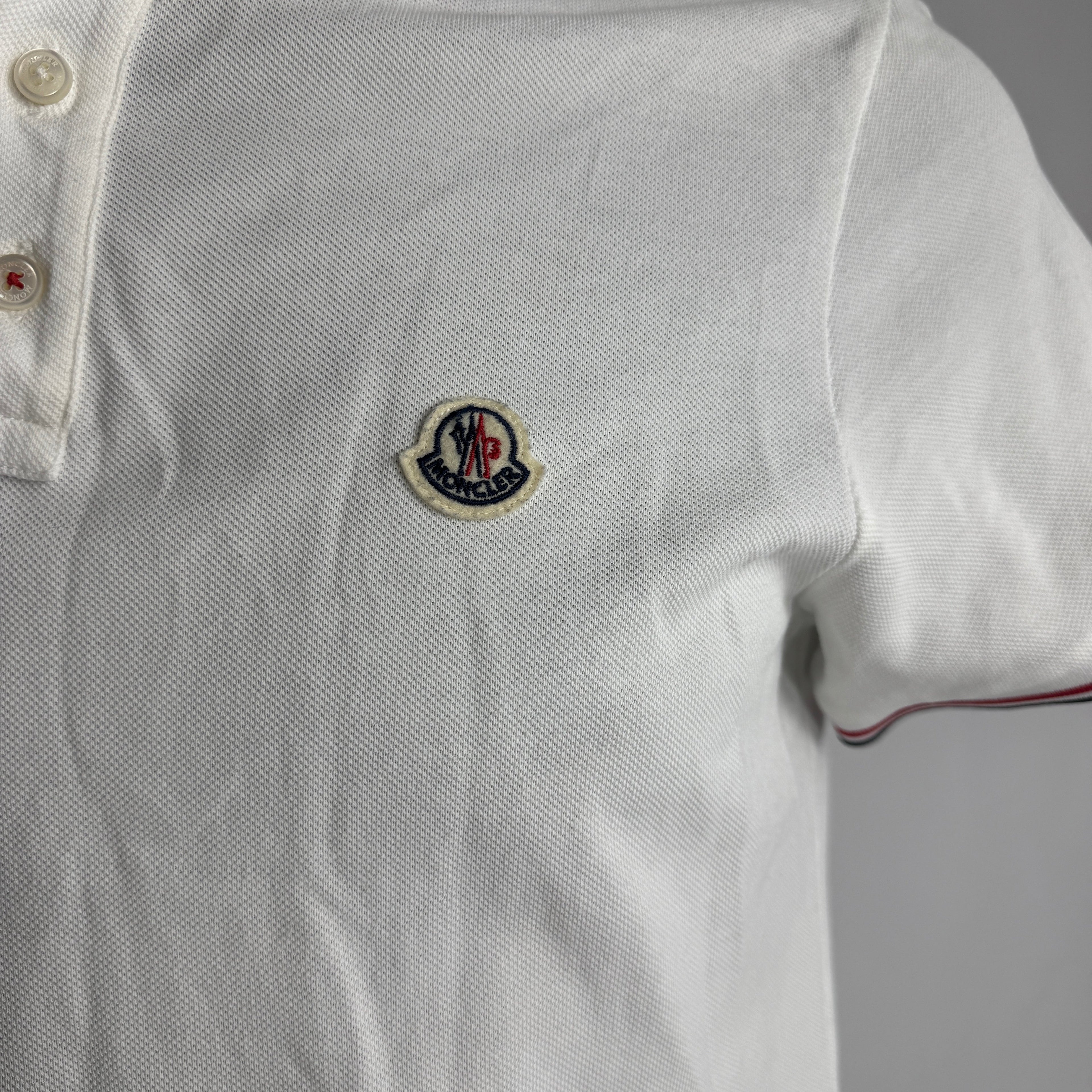 Moncler Polo Shirt crafted from premium cotton piqué, featuring a classic collar, button placket, signature logo patch, and