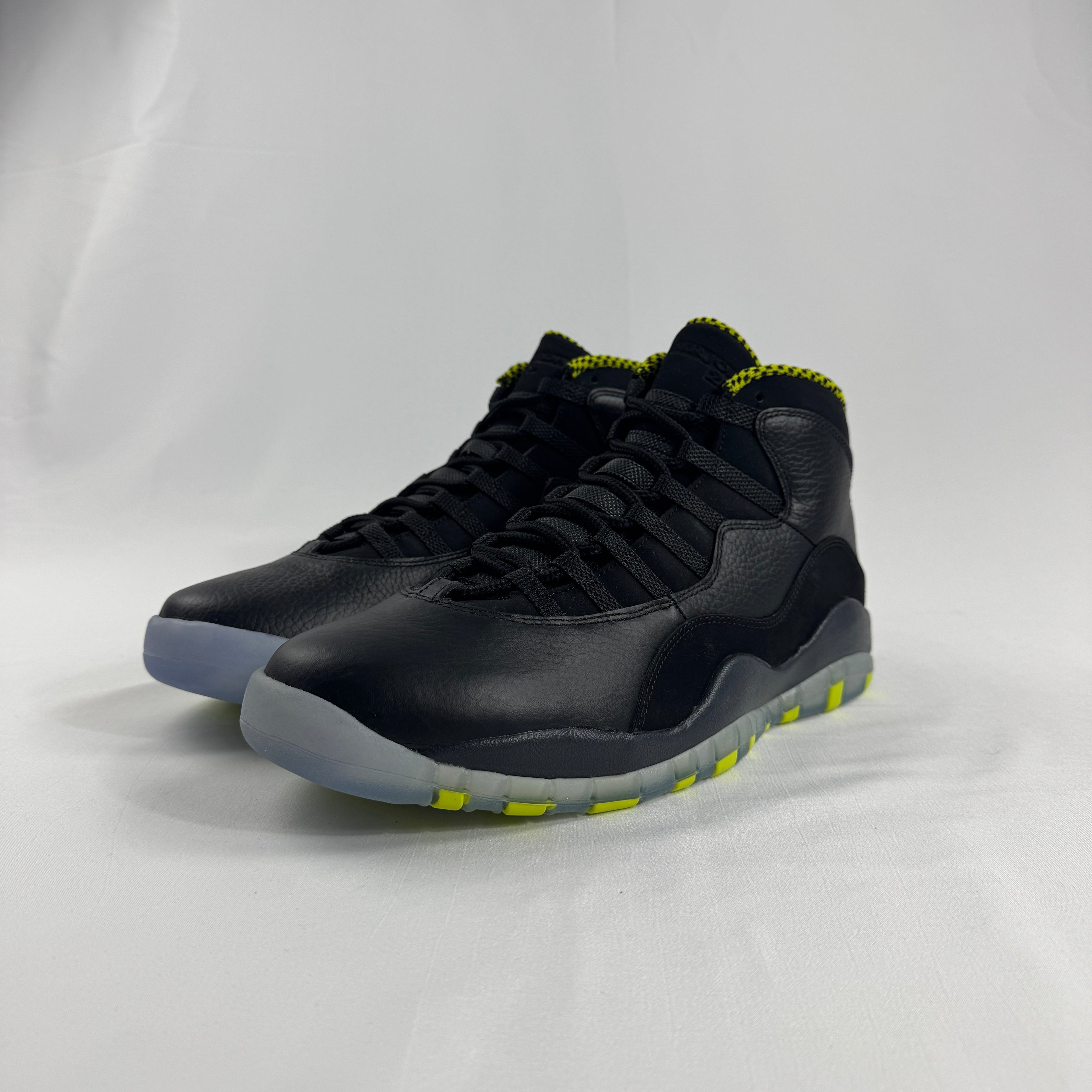 The Nike Air Jordan 10 Retro Black Venom features a sleek black tumbled leather upper paired with vibrant Venom Green