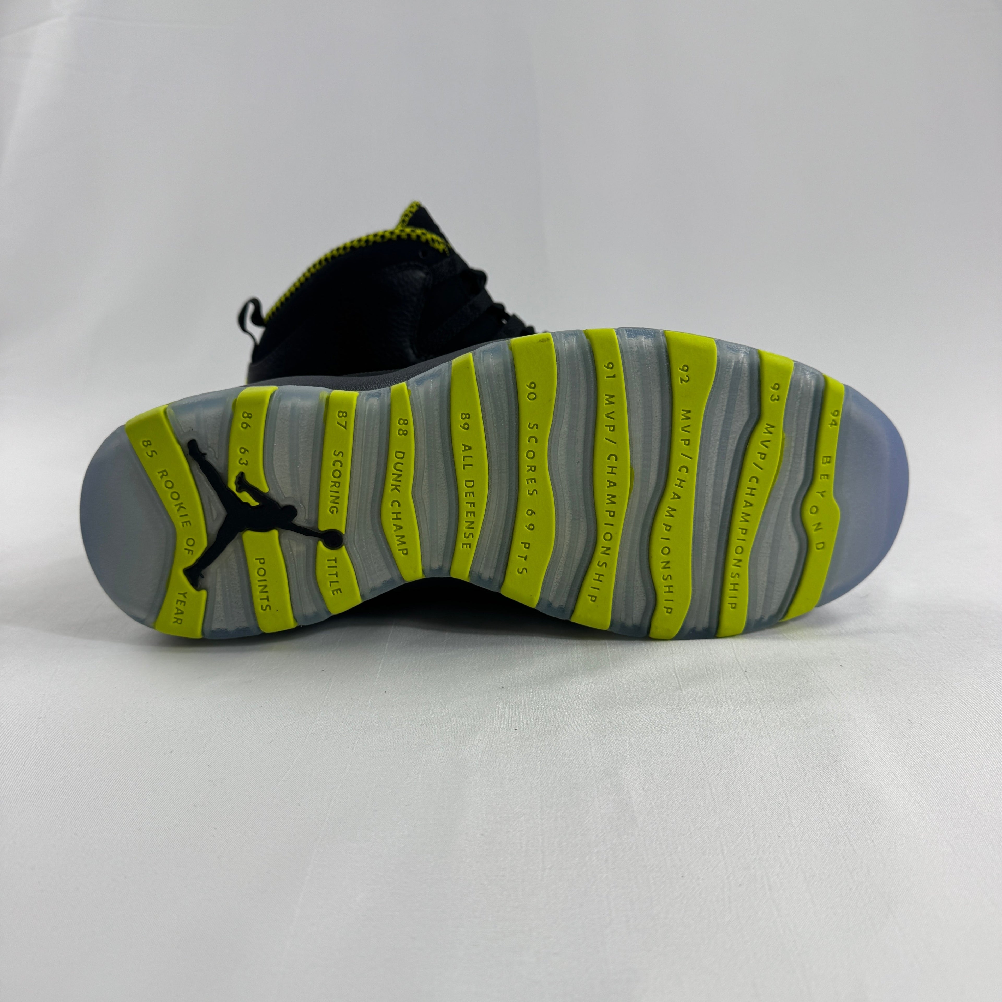 The Nike Air Jordan 10 Retro Black Venom features a sleek black tumbled leather upper paired with vibrant Venom Green