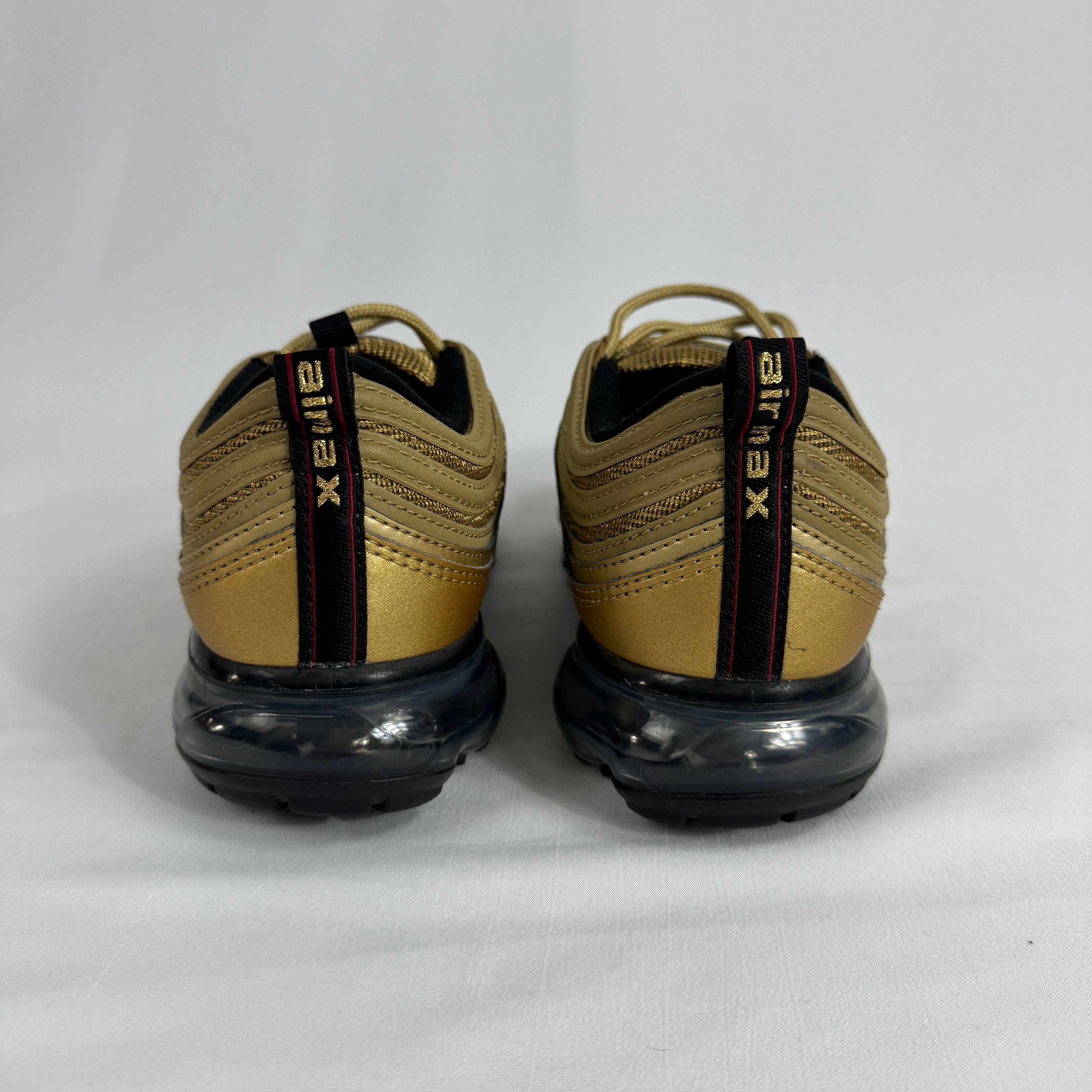 The Nike Air VaporMax 97 Metallic Gold combines the iconic Air Max 97 design with full-length VaporMax cushioning, featuring