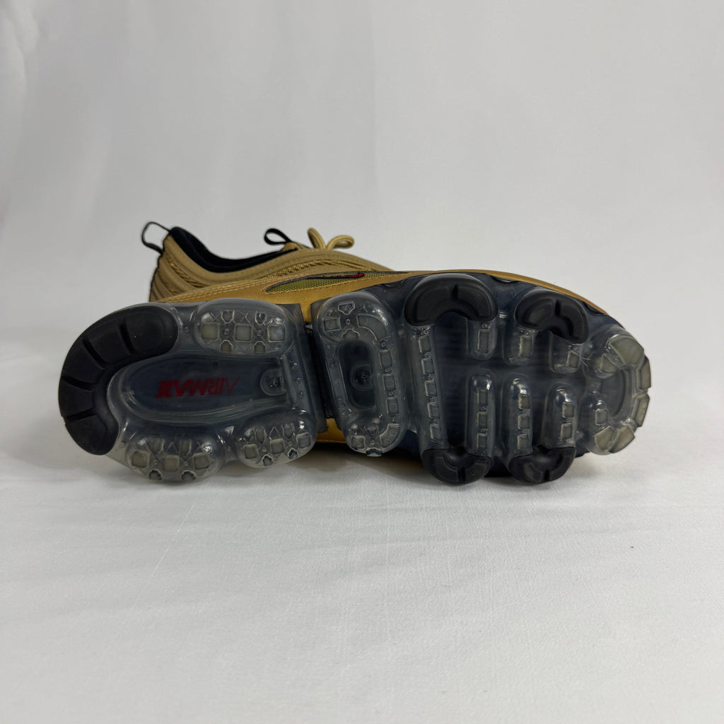 The Nike Air VaporMax 97 Metallic Gold combines the iconic Air Max 97 design with full-length VaporMax cushioning, featuring