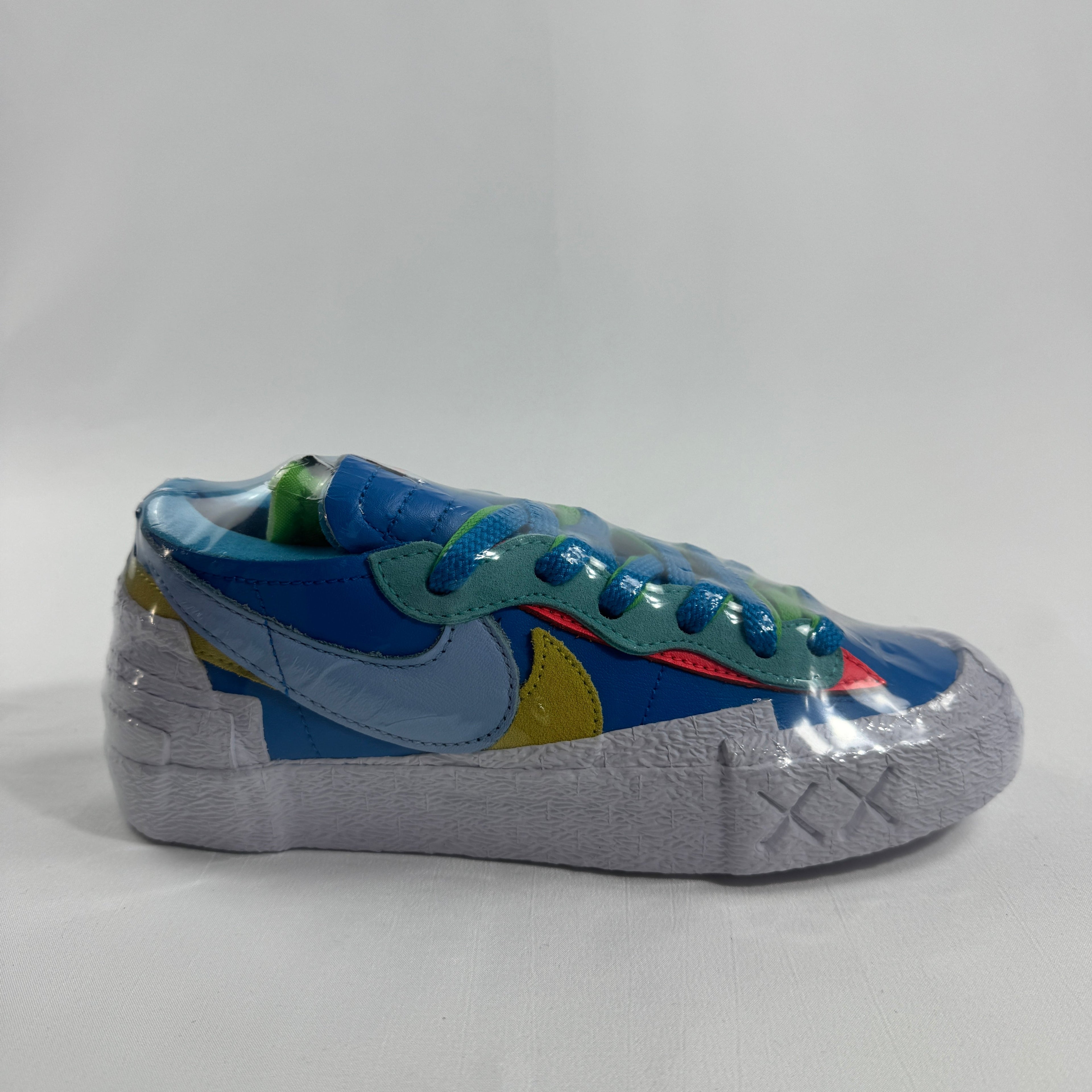 Nike Blazer Low / Sacai / KAWS is a collaborative reinterpretation of the classic Blazer Low, blending Sacai’s deconstructed