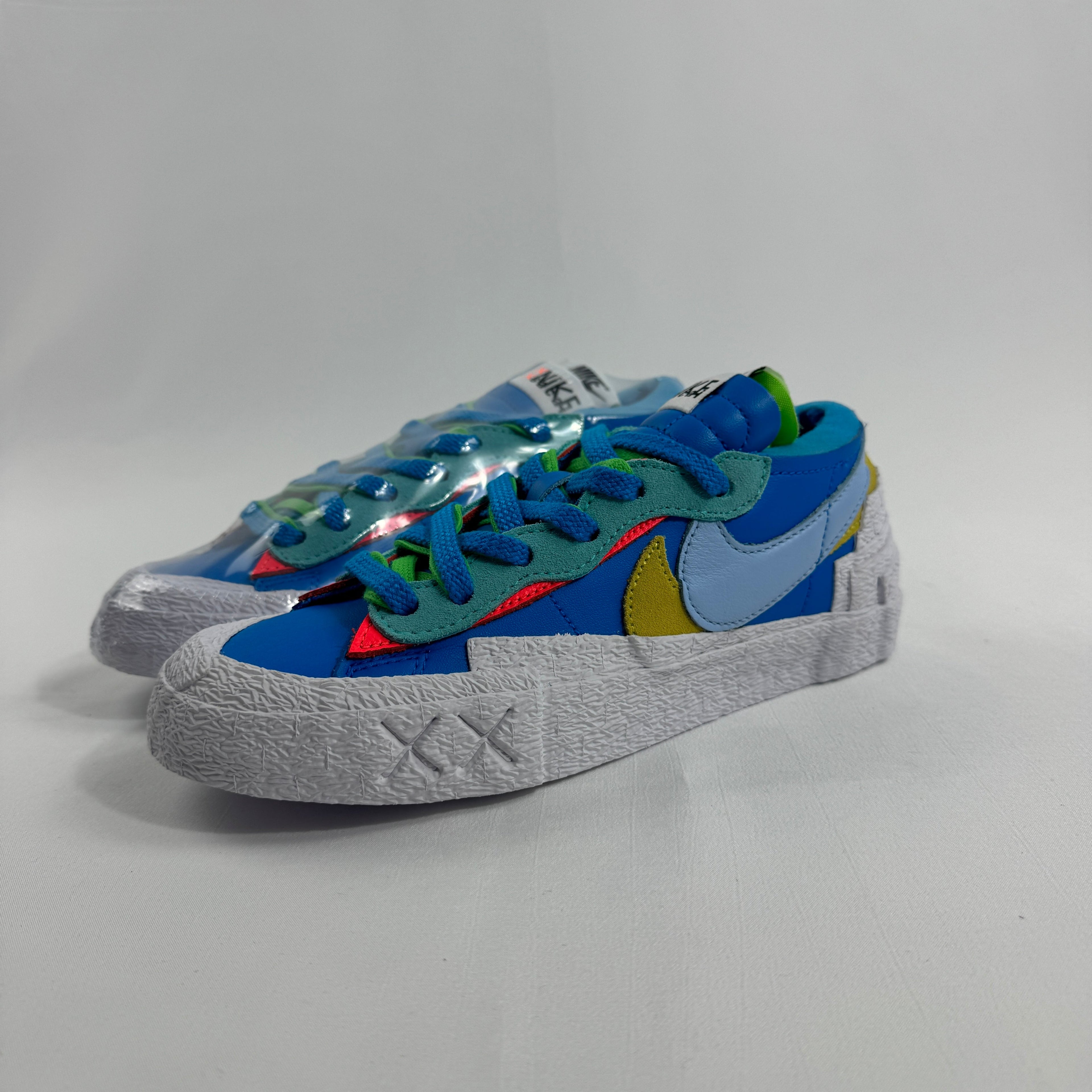 Nike Blazer Low / Sacai / KAWS is a collaborative reinterpretation of the classic Blazer Low, blending Sacai’s deconstructed