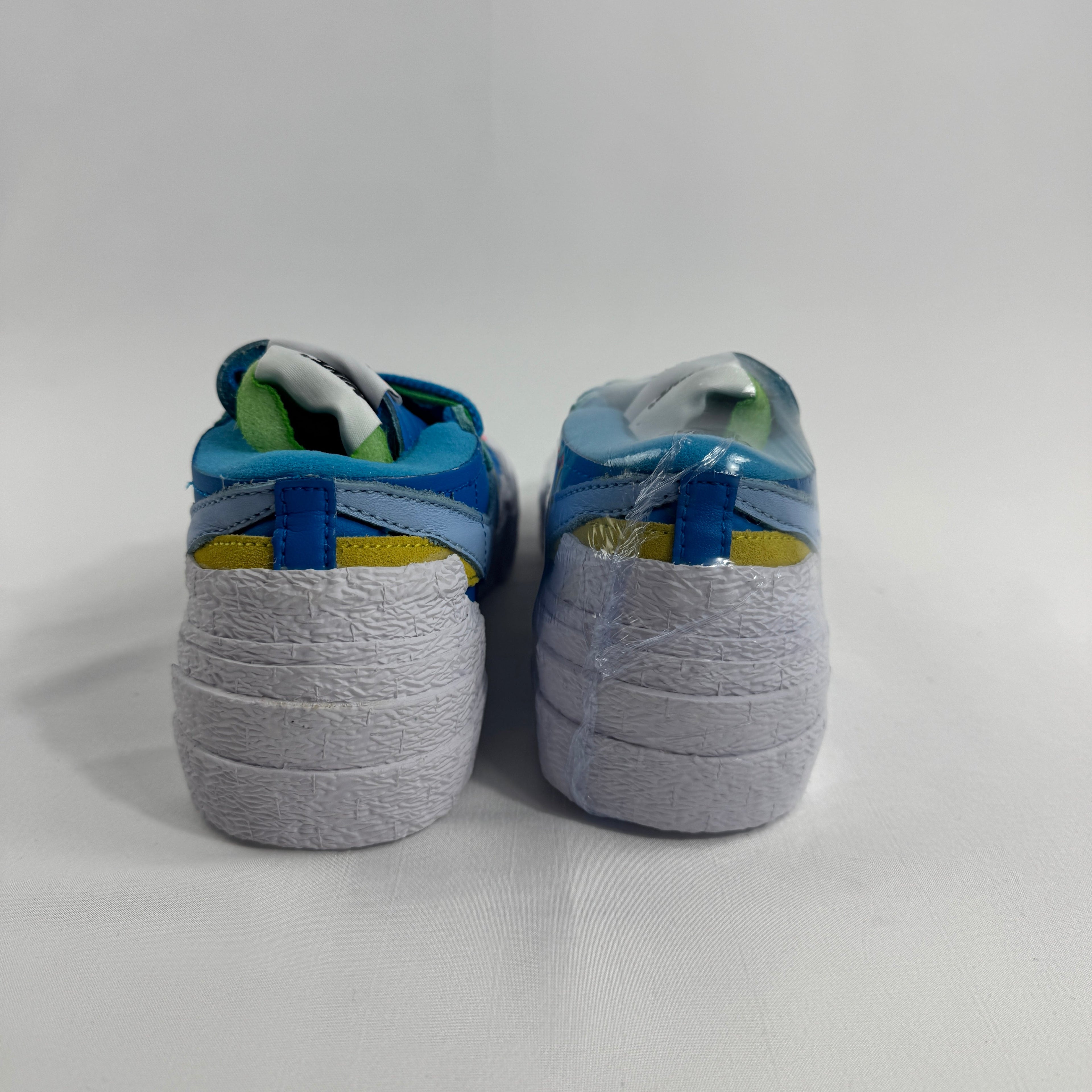 Nike Blazer Low / Sacai / KAWS is a collaborative reinterpretation of the classic Blazer Low, blending Sacai’s deconstructed