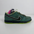 Nike SB Dunk Low trainer with a green upper, black swoosh, lime green sole, and white tongue on a white background.