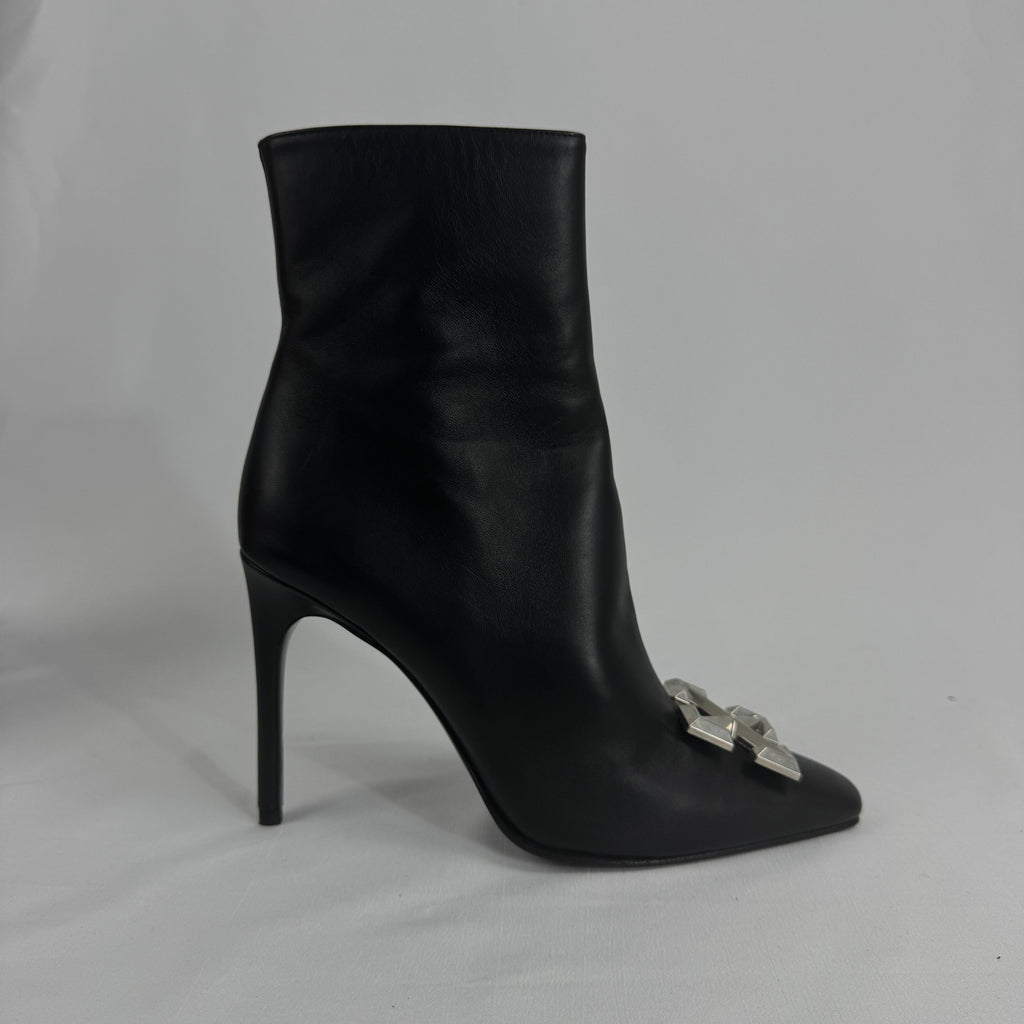 The Off-White Arrow Heels reinterpret classic high-heel design through the brand’s signature streetwear lens. Crafted from