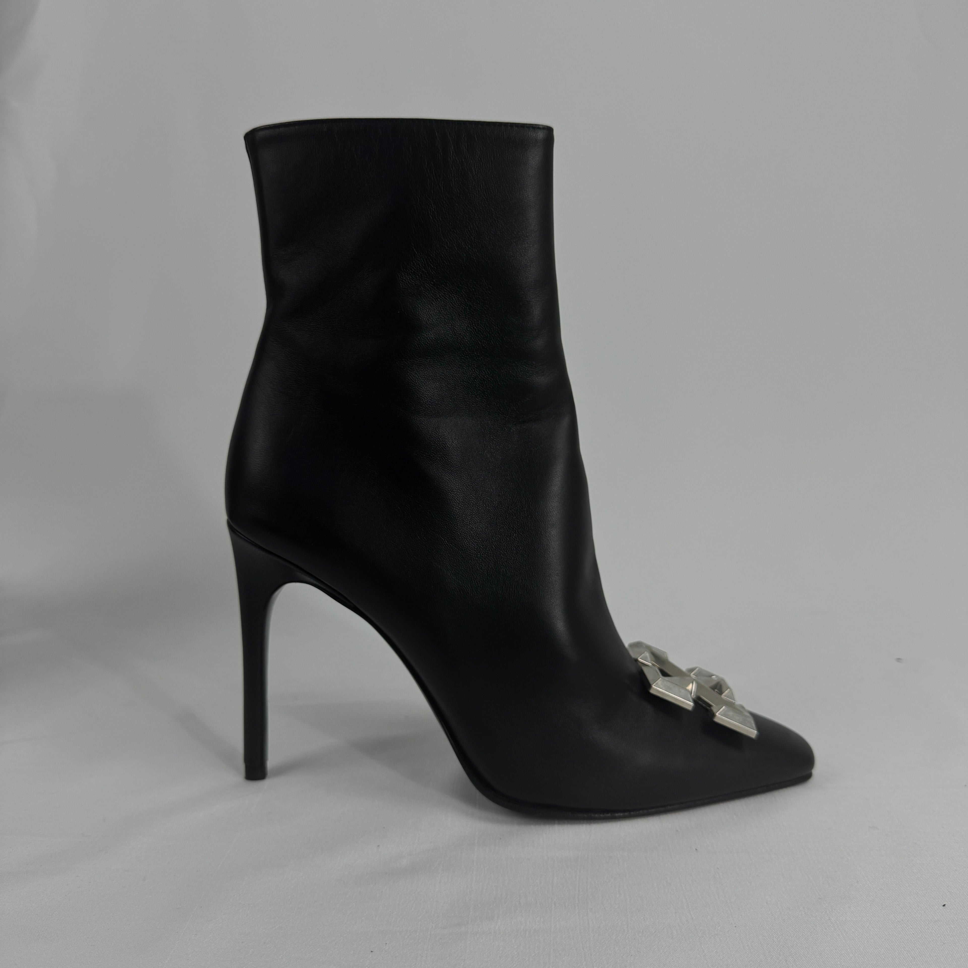 The Off-White Arrow Heels reinterpret classic high-heel design through the brand’s signature streetwear lens. Crafted from