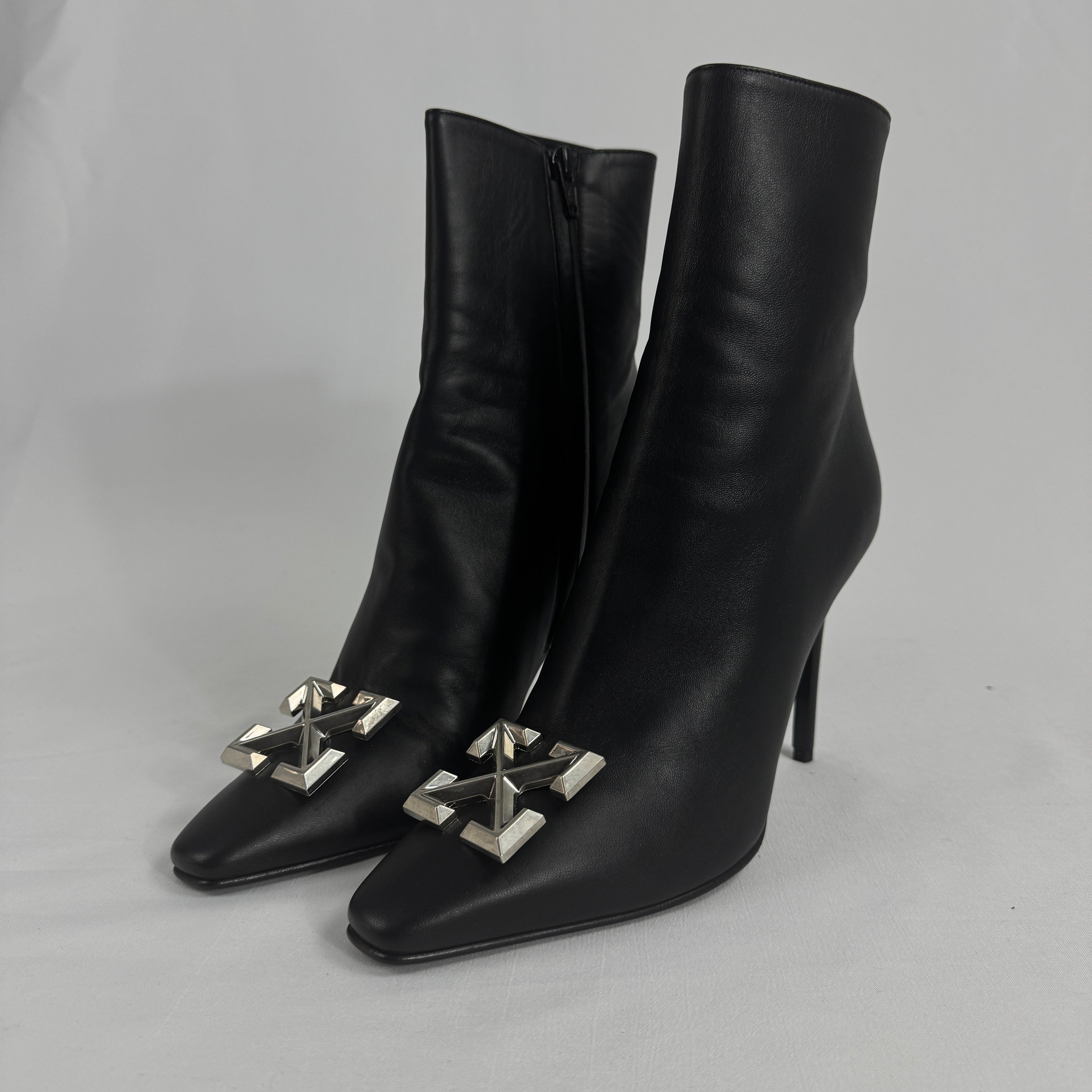 The Off-White Arrow Heels reinterpret classic high-heel design through the brand’s signature streetwear lens. Crafted from