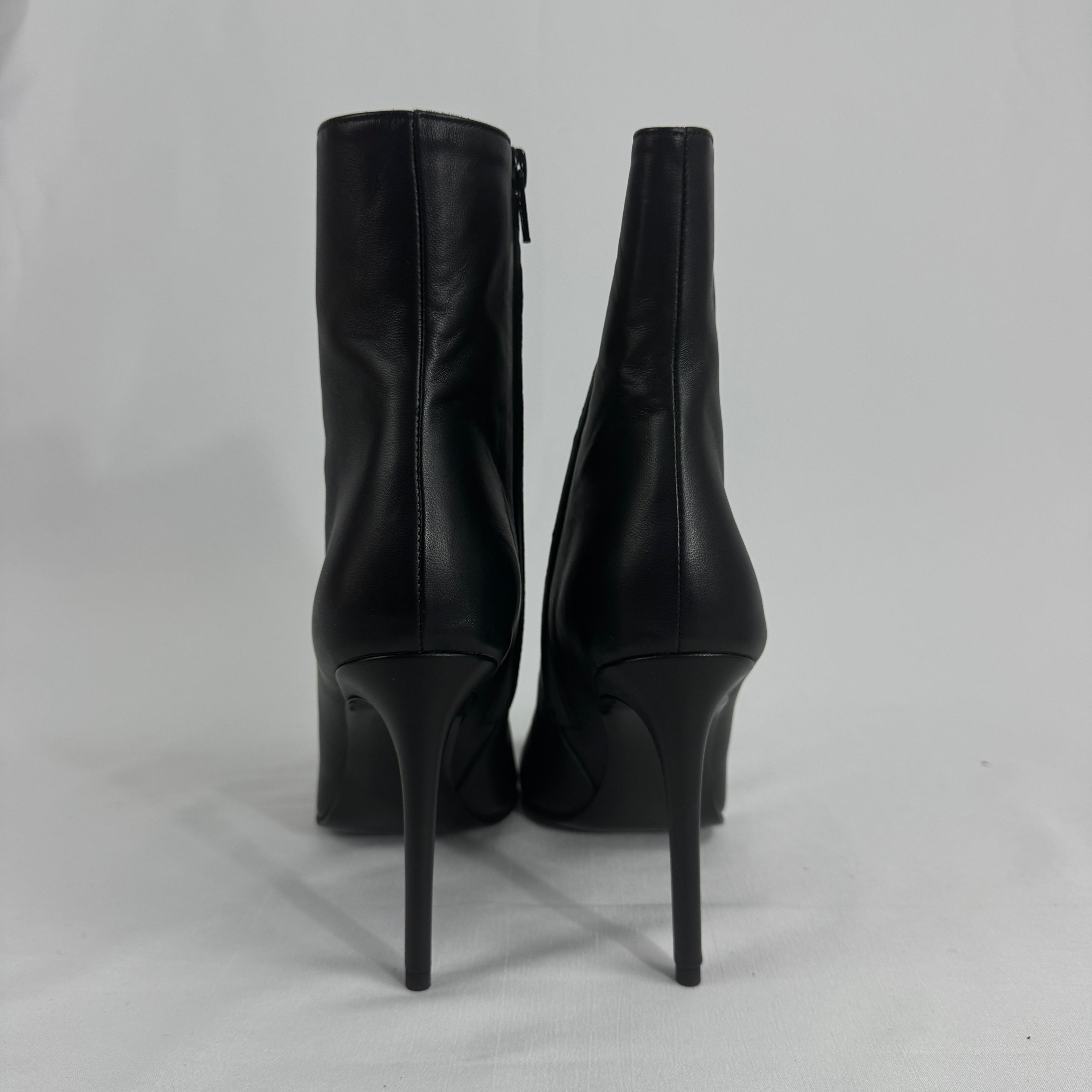 The Off-White Arrow Heels reinterpret classic high-heel design through the brand’s signature streetwear lens. Crafted from