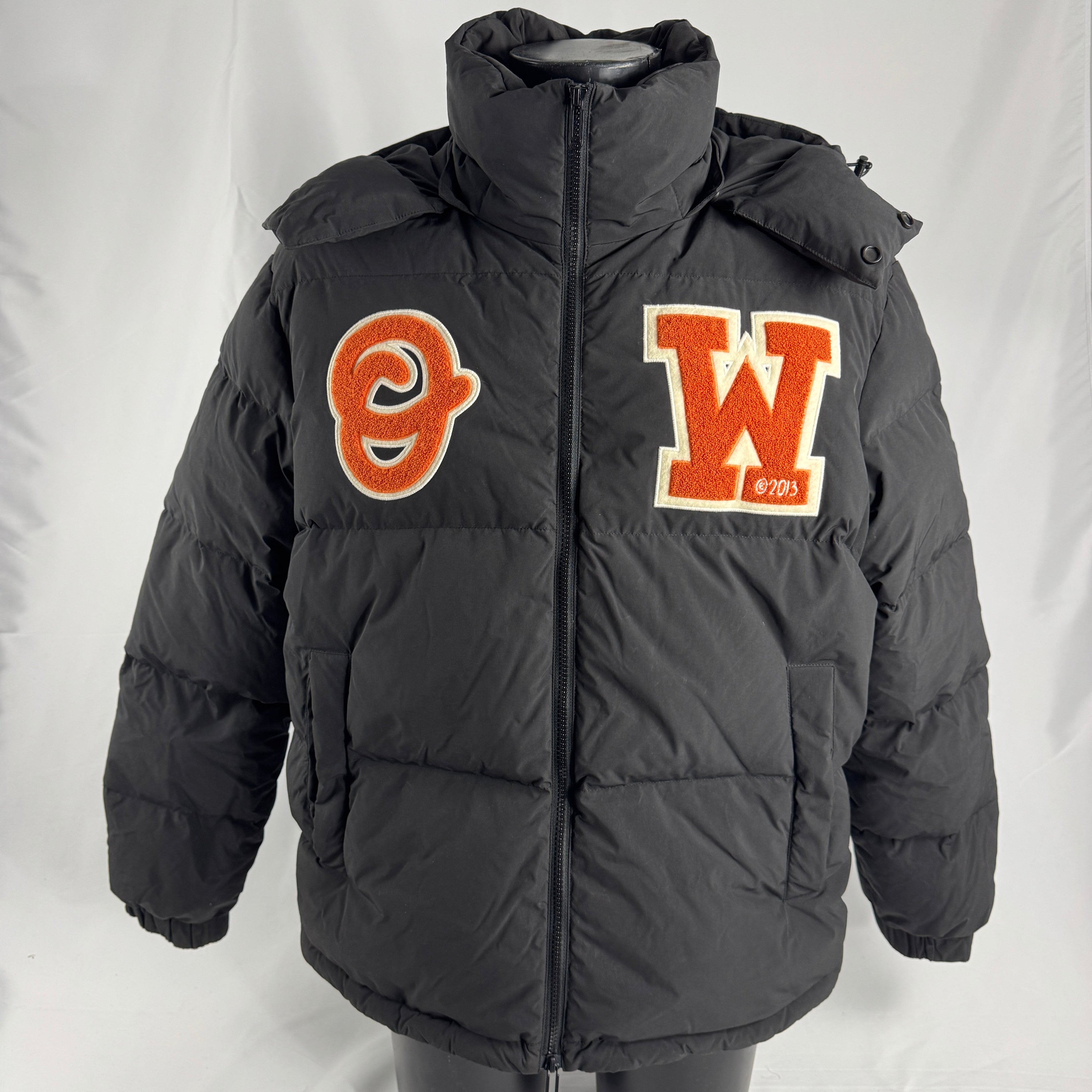 The Off-White Patch Puffer Jacket is a padded winter jacket featuring premium insulation, a relaxed fit, and signature