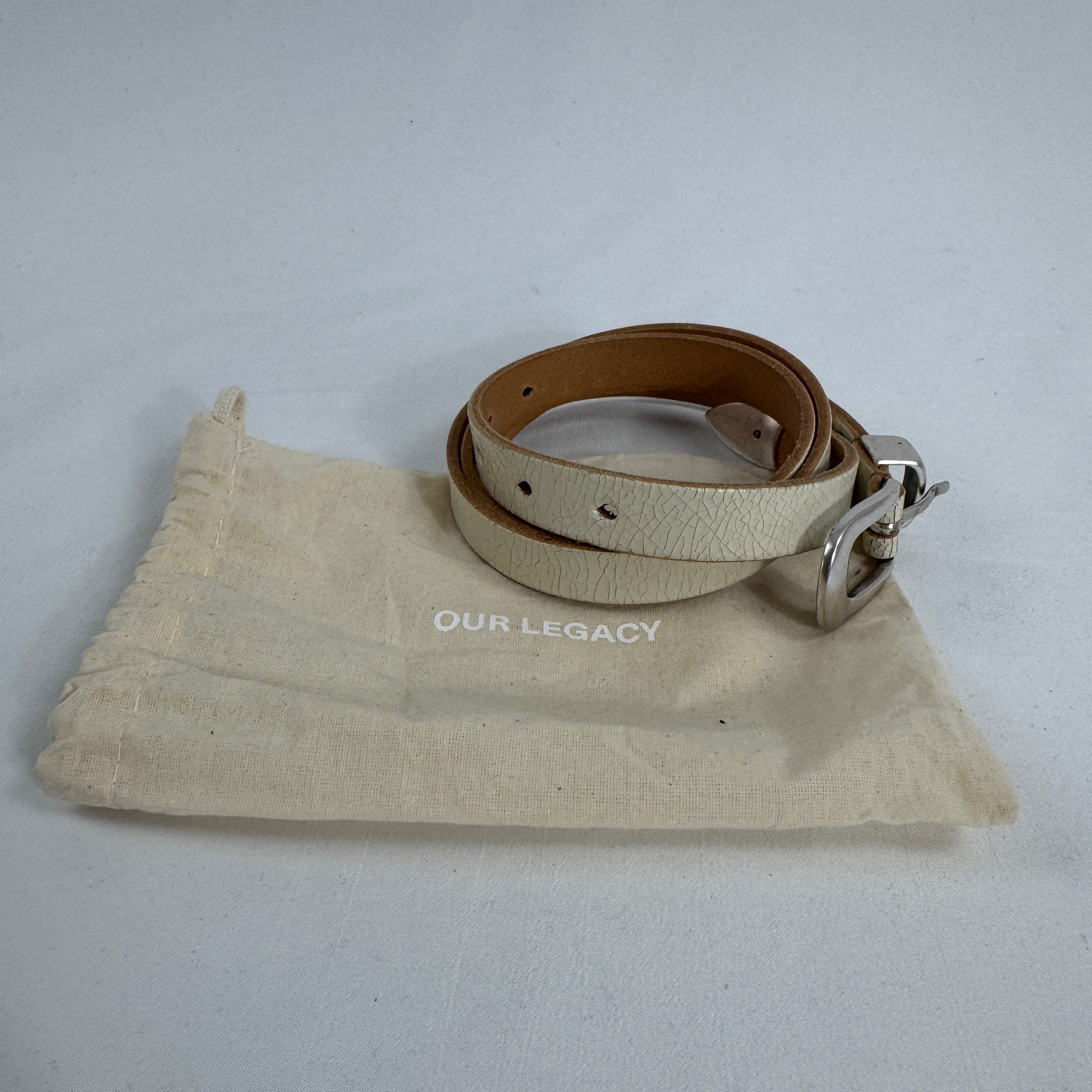 The Our Legacy White Belt Cracked is a premium leather belt crafted from cracked-finish leather for a distinctive worn-in
