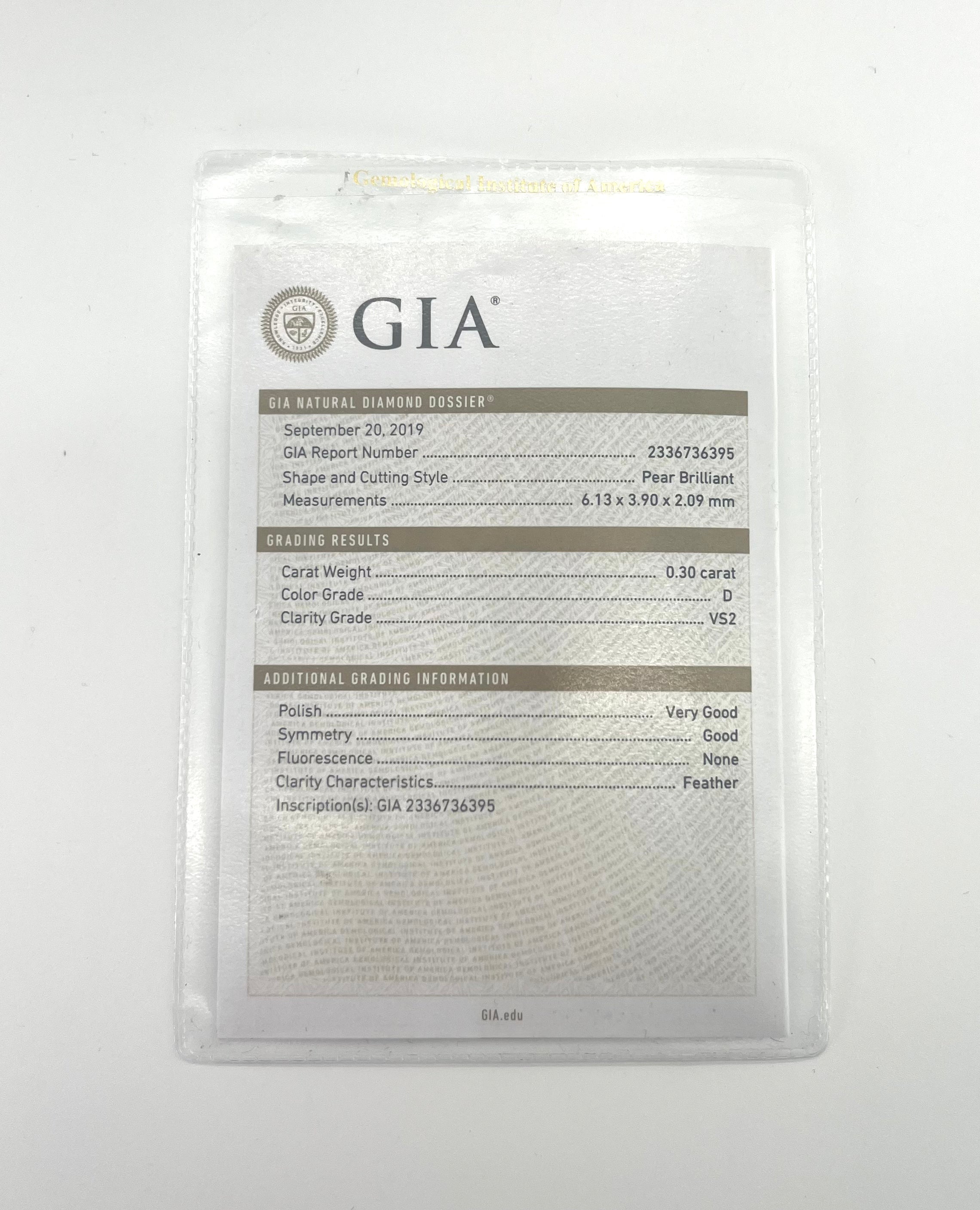 A GIA diamond dossier in a transparent sleeve displays details for a pear cut diamond from CB STORES, shown alongside the gem.