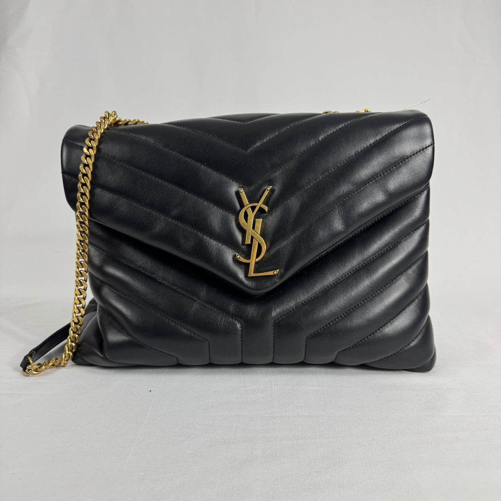 The Saint Laurent LouLou Crossbody Bag is a quilted leather handbag featuring the signature YSL logo, a chain strap, and a