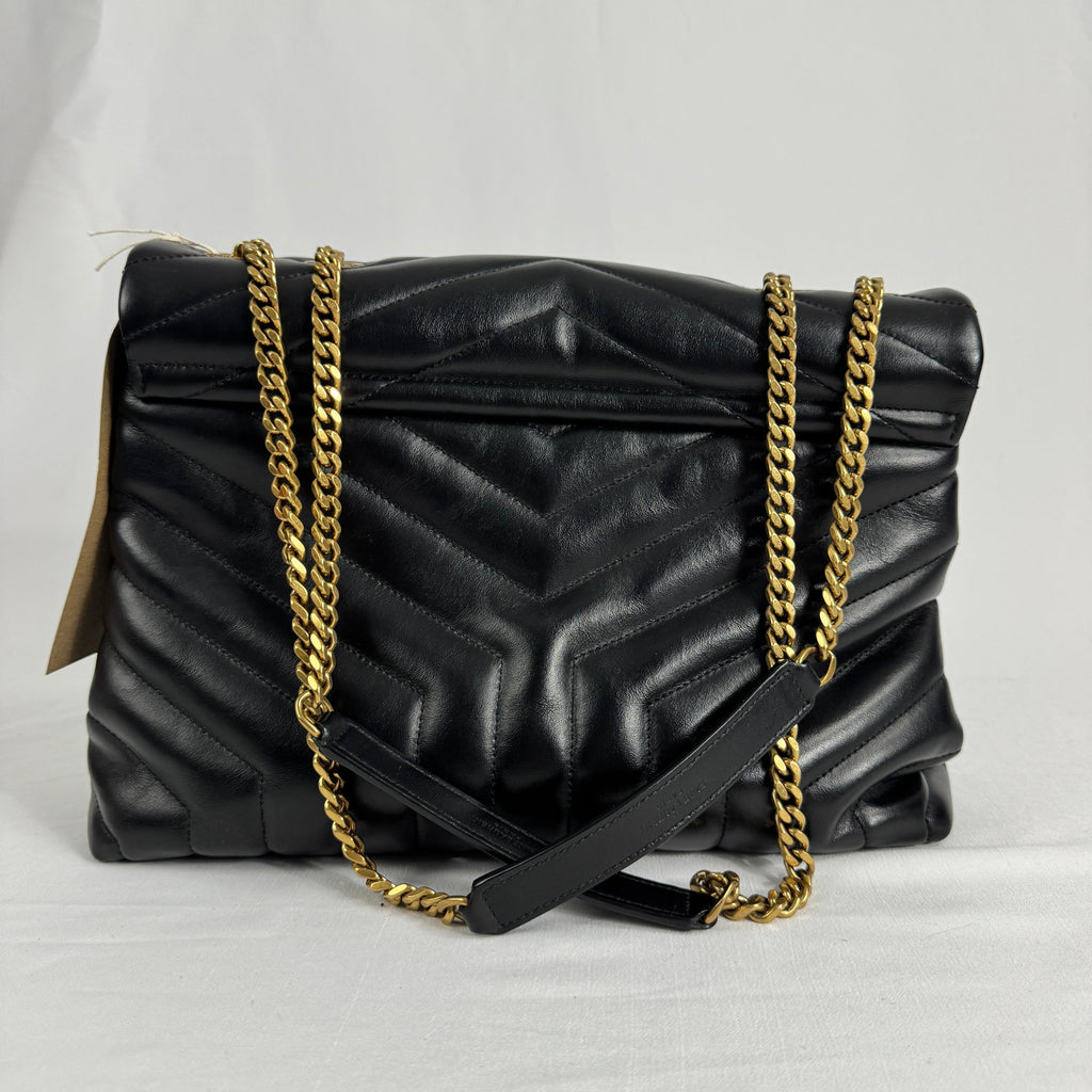 The Saint Laurent LouLou Crossbody Bag is a quilted leather handbag featuring the signature YSL logo, a chain strap, and a