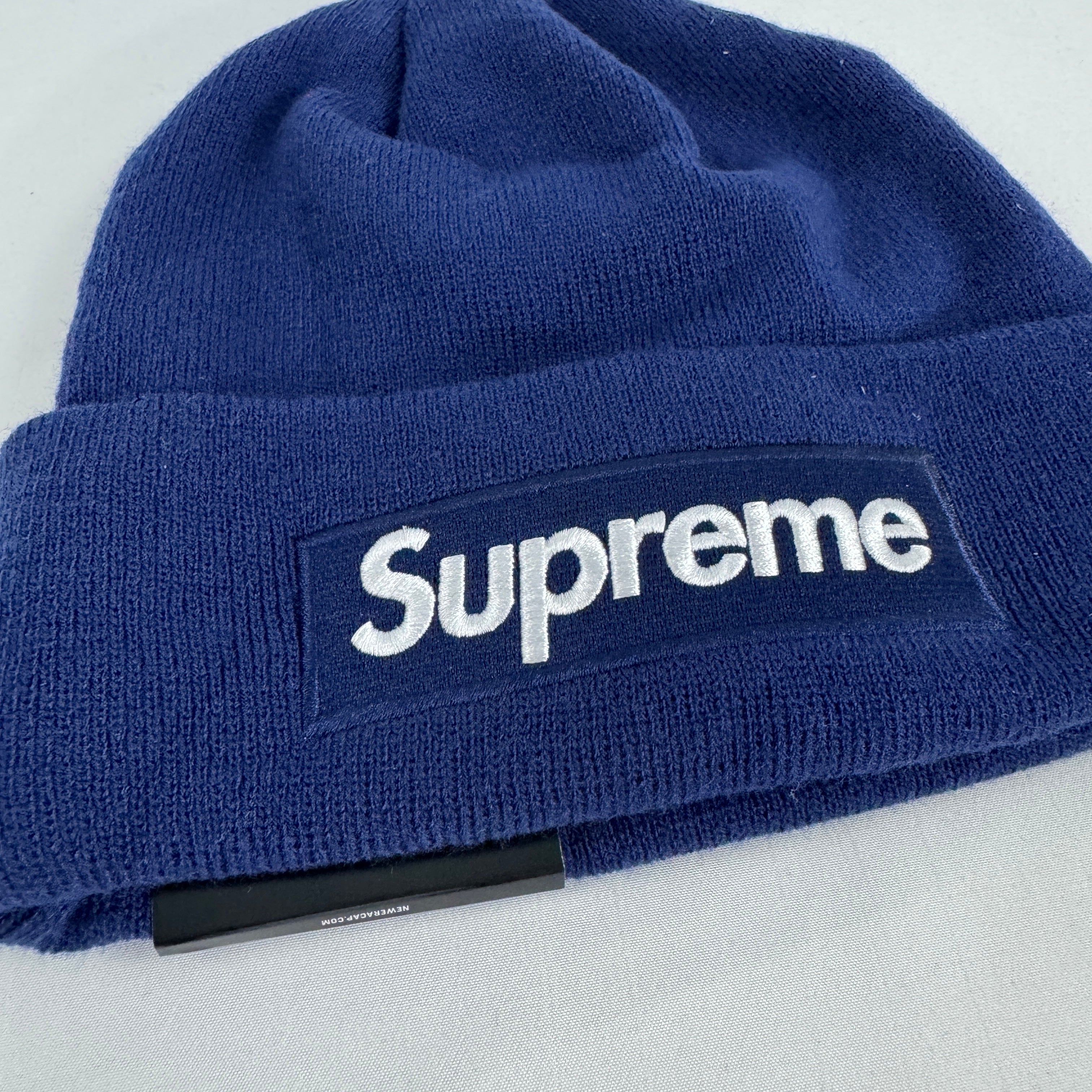 The Supreme Box Logo Beanie Navy is a ribbed knit winter hat featuring the iconic Supreme box logo stitched on the front