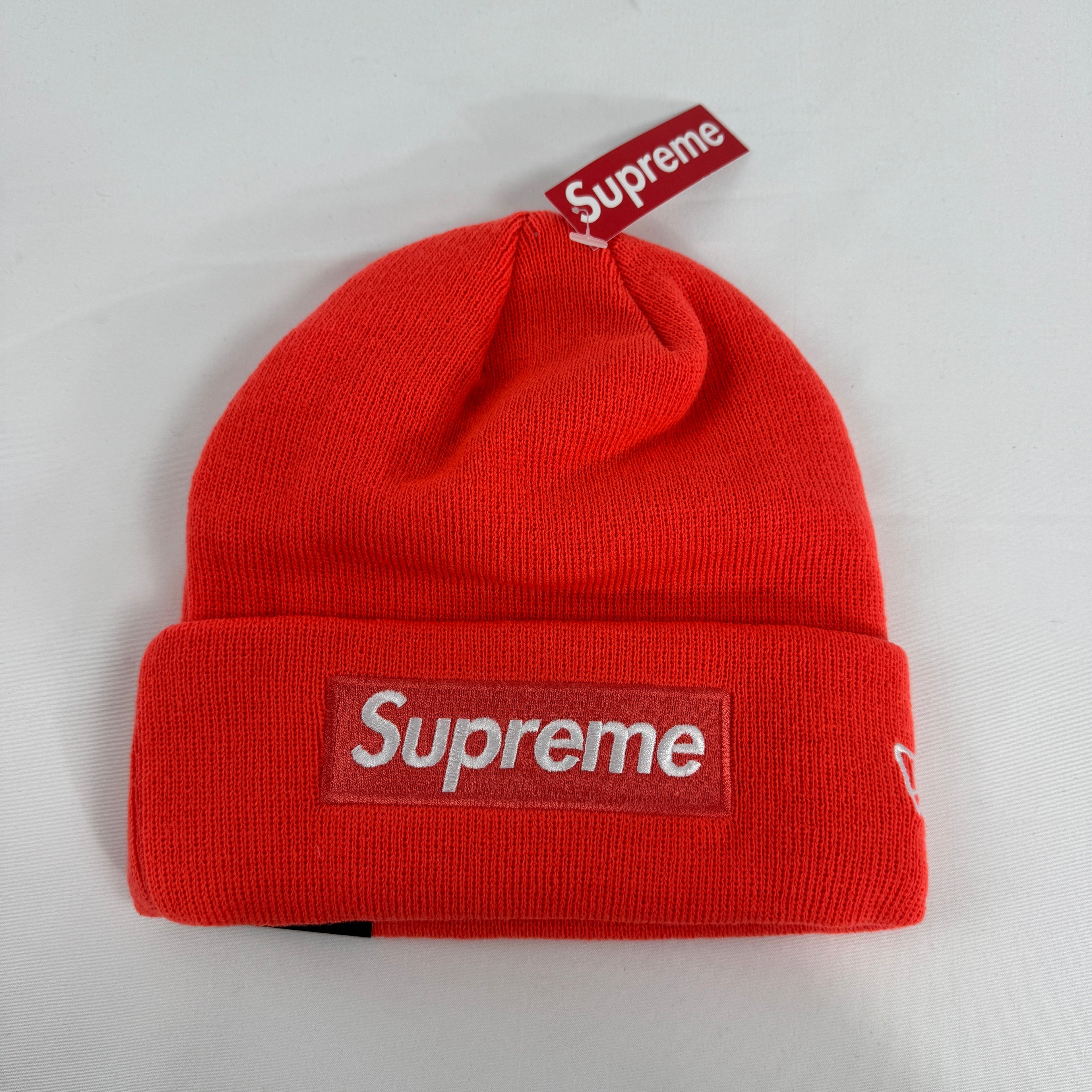 The Supreme Box Logo Beanie in fluorescent orange is a ribbed knit hat featuring the iconic Supreme box logo stitched on the