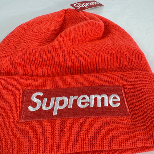 The Supreme Box Logo Beanie in fluorescent orange is a ribbed knit hat featuring the iconic Supreme box logo stitched on the
