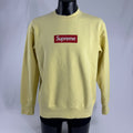 The Supreme Box Logo in pale yellow refers to a signature Supreme piece featuring the iconic box logo graphic set against a